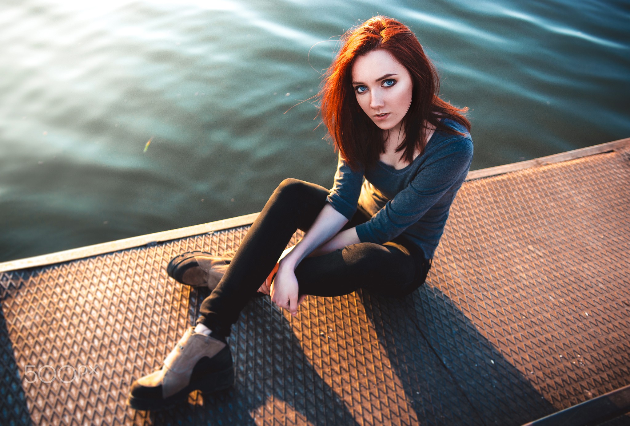 Redhead woman with blue eyes sitting by the water HD Wallpaper