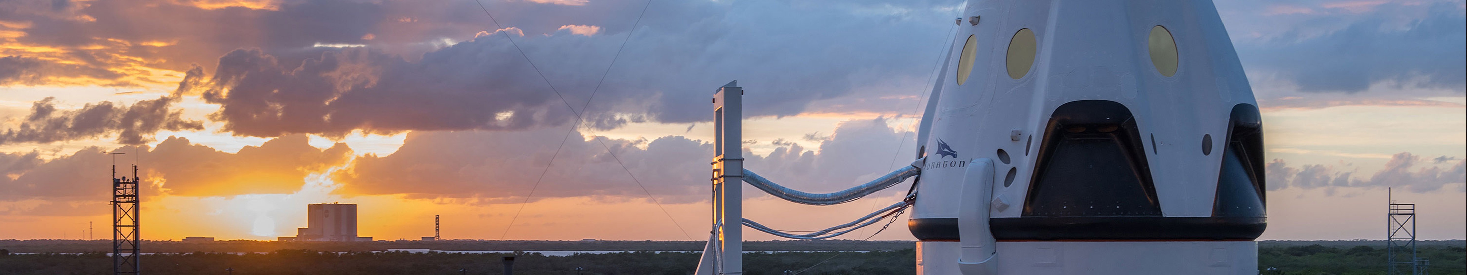 SpaceX rocket capsule at sunrise with launch tower HD Wallpaper