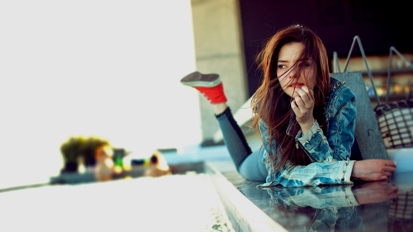 Woman in denim jacket lying down HD Wallpaper