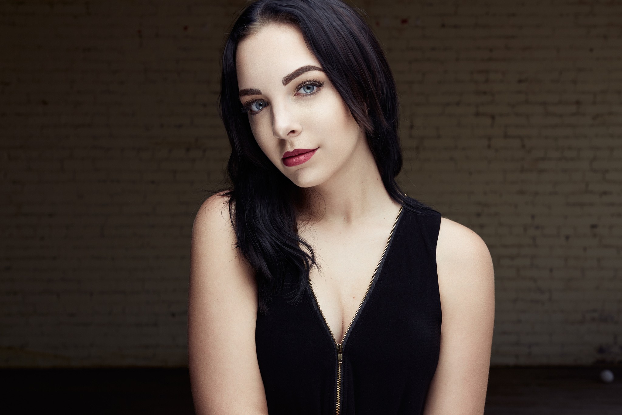 Portrait of Katie Tullo in front of a brick wall HD Wallpaper