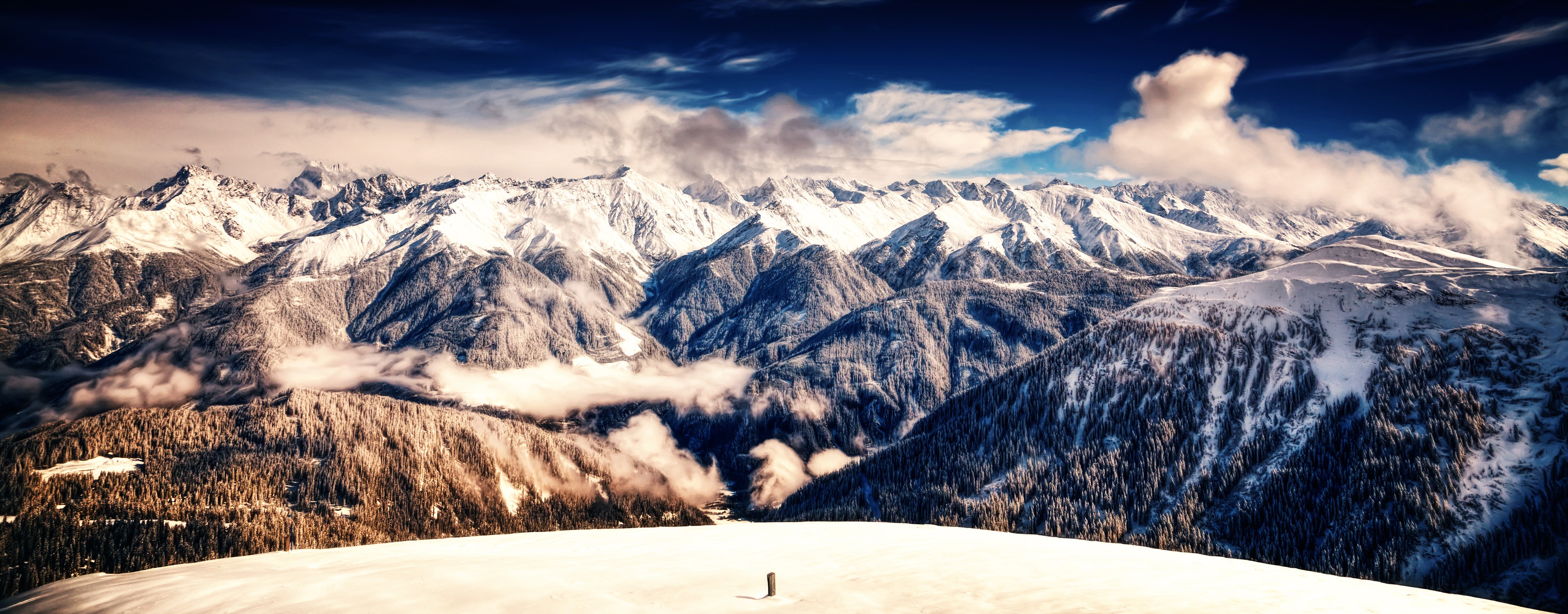 Panoramic view of snow-covered mountains HD Wallpaper