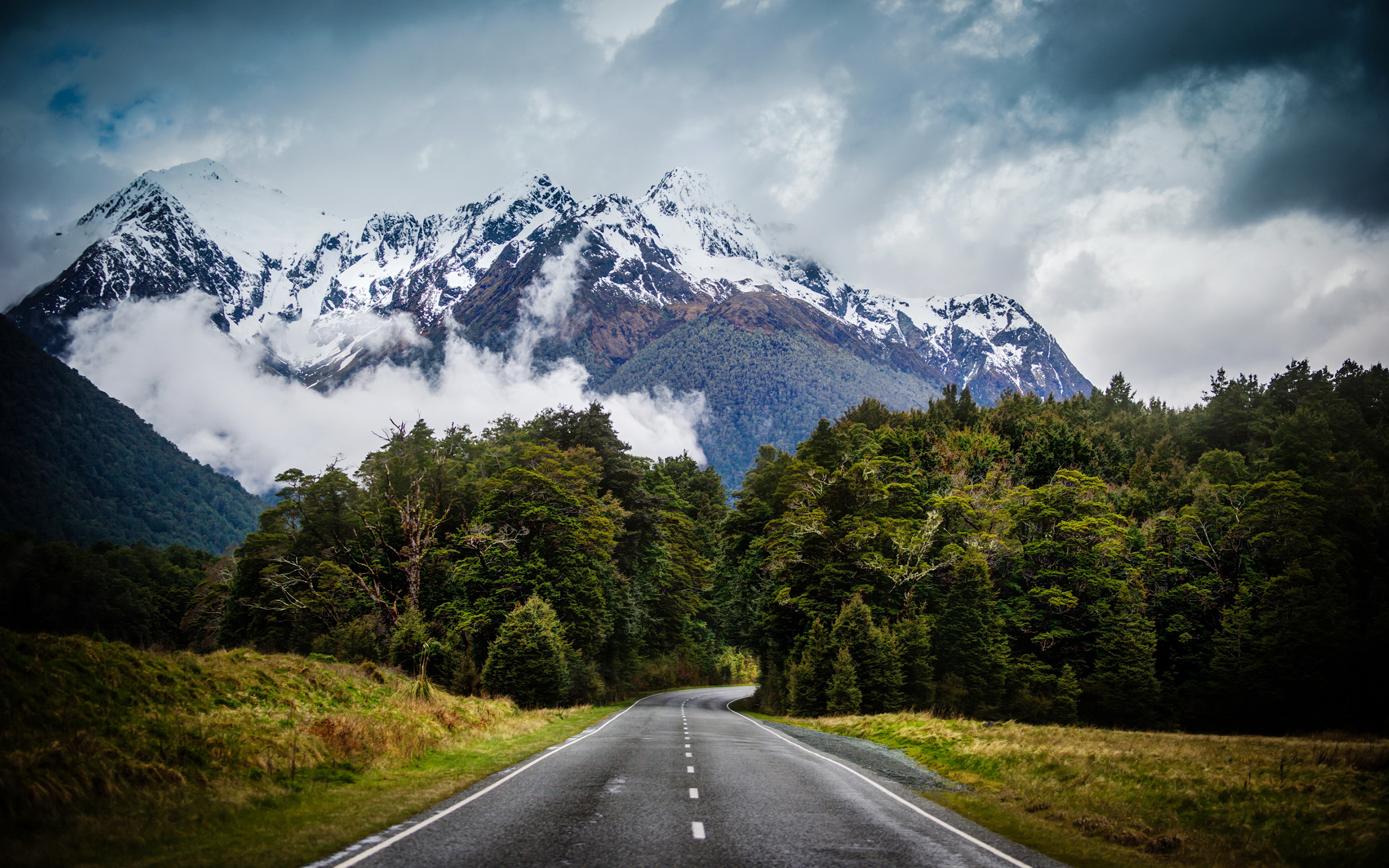 Road leading to snow-capped mountains in New Zealand HD Wallpaper