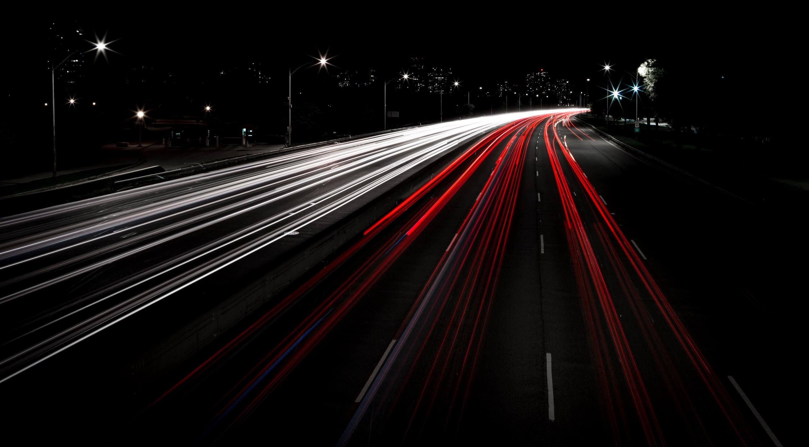 Light trails on a highway at night HD Wallpaper