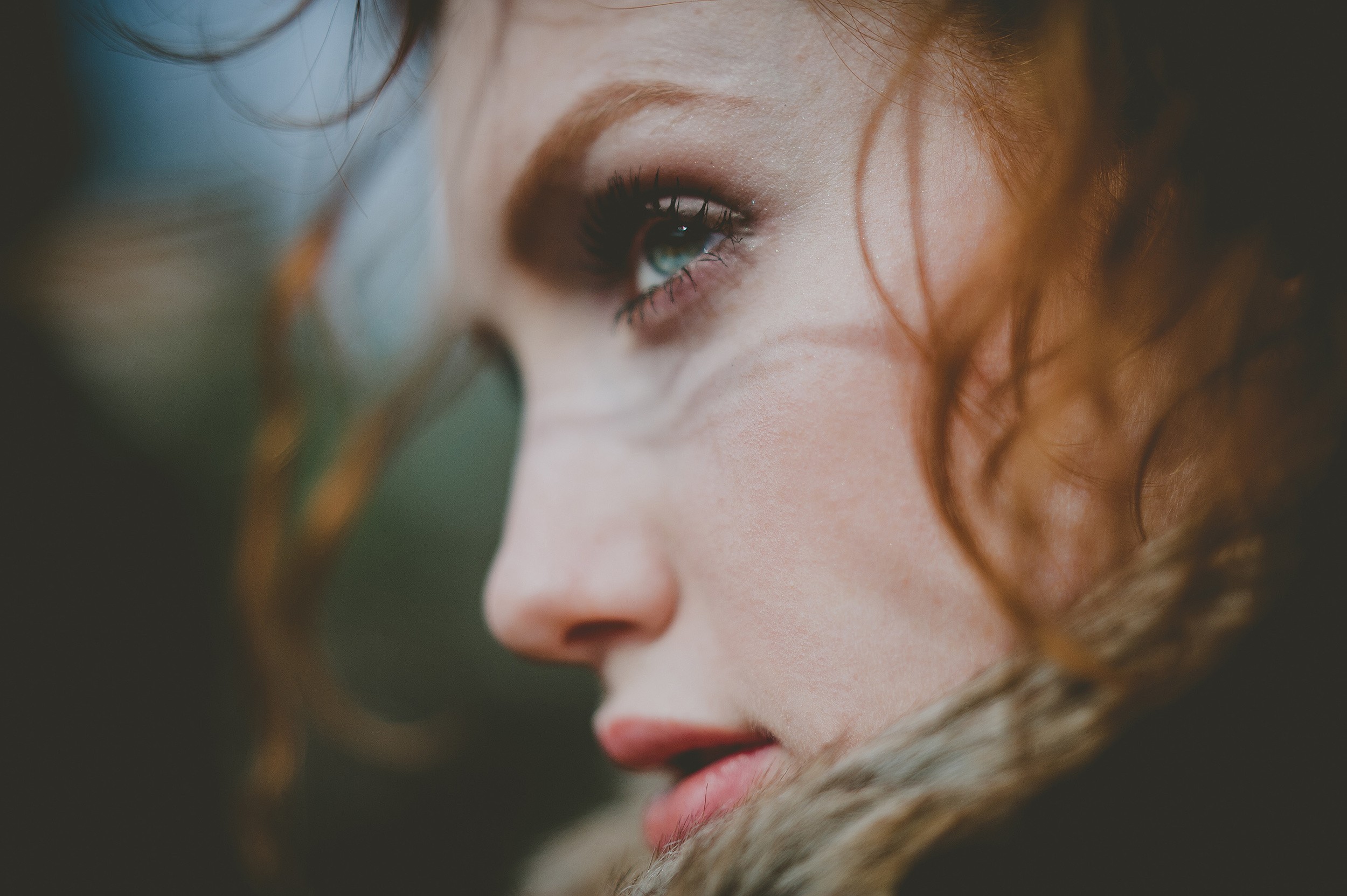 Close-up of a redhead woman with blue eyes looking away HD Wallpaper