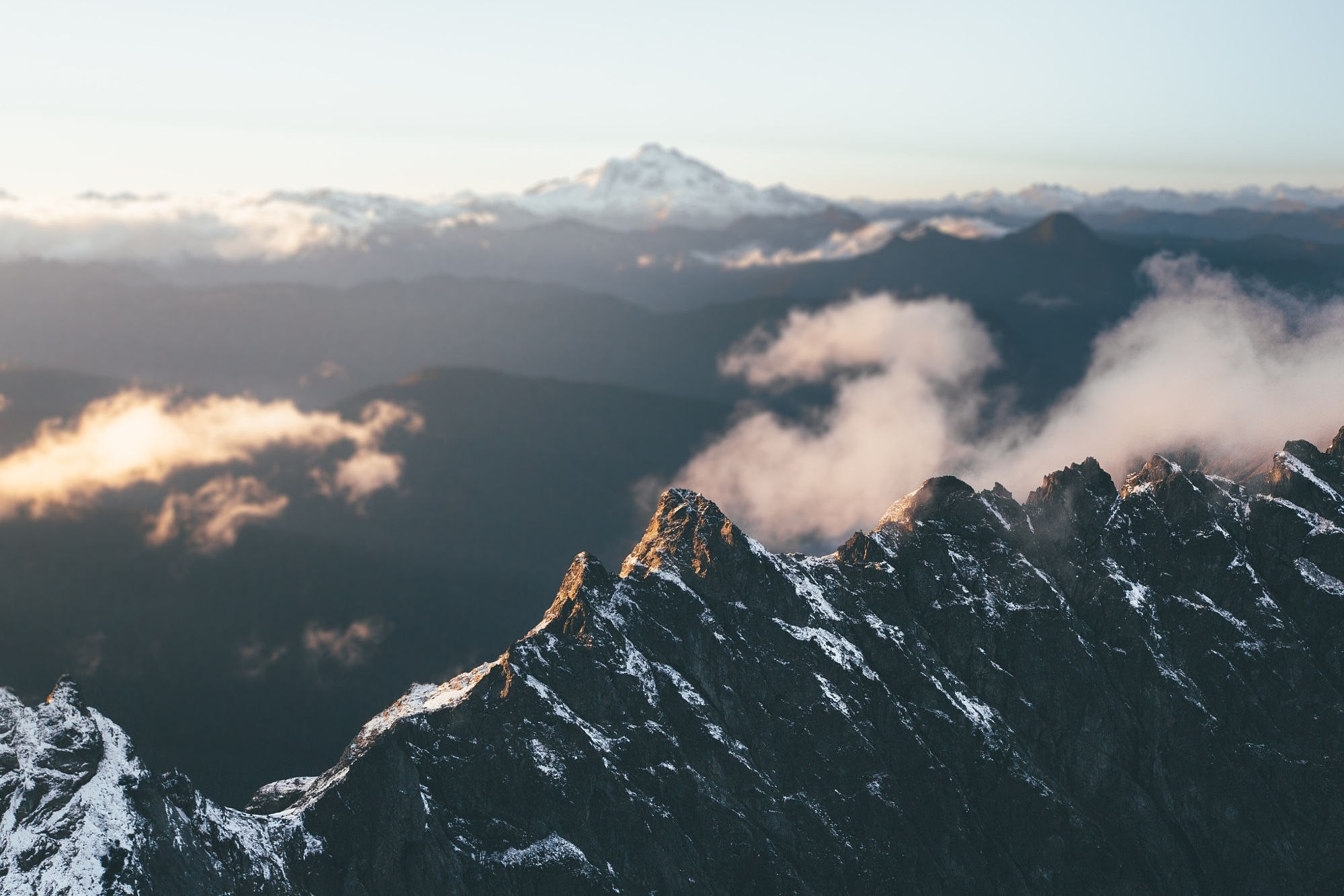 Snow-capped mountains with clouds at sunrise HD Wallpaper