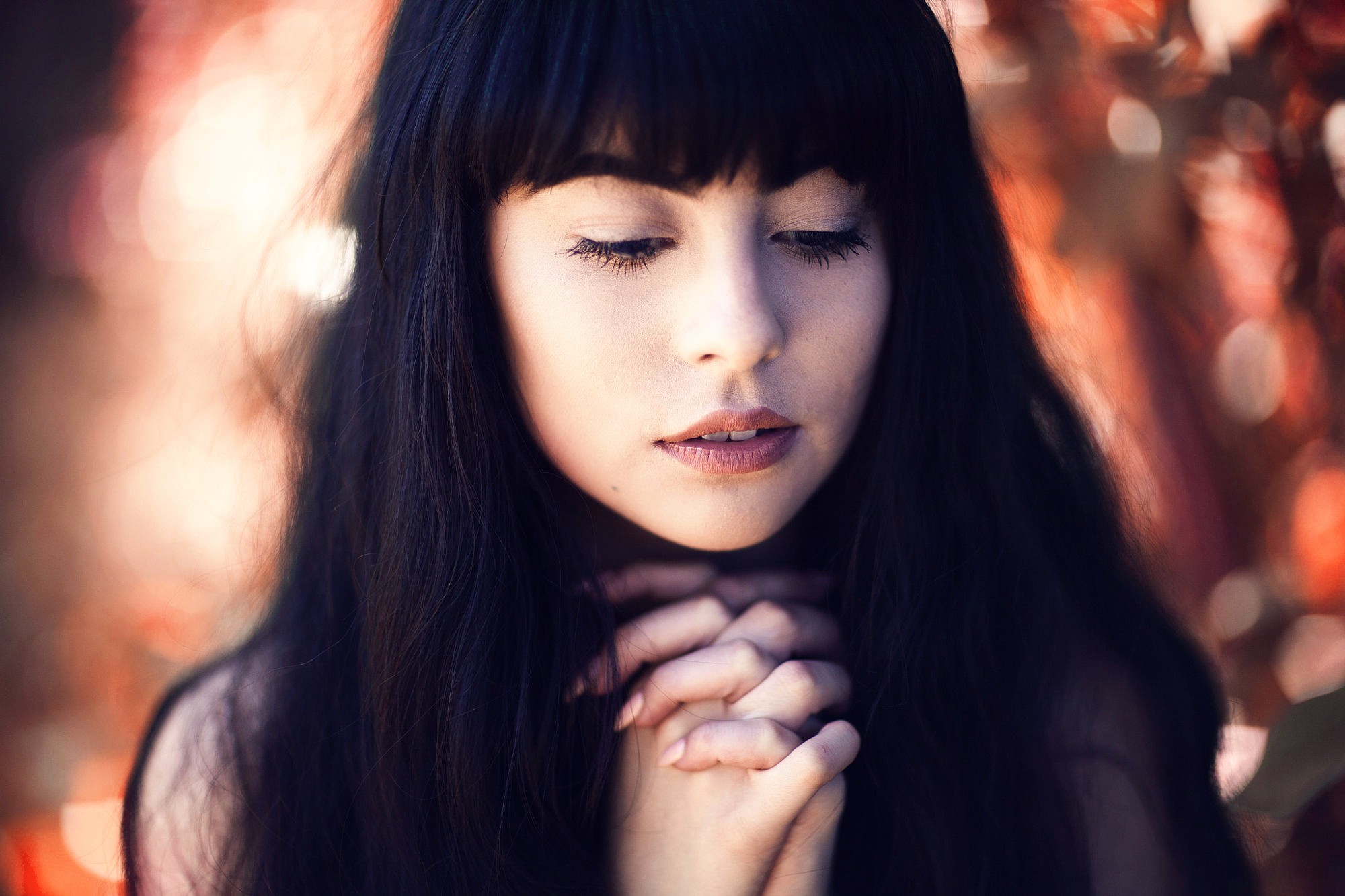 Woman with dark hair praying HD Wallpaper