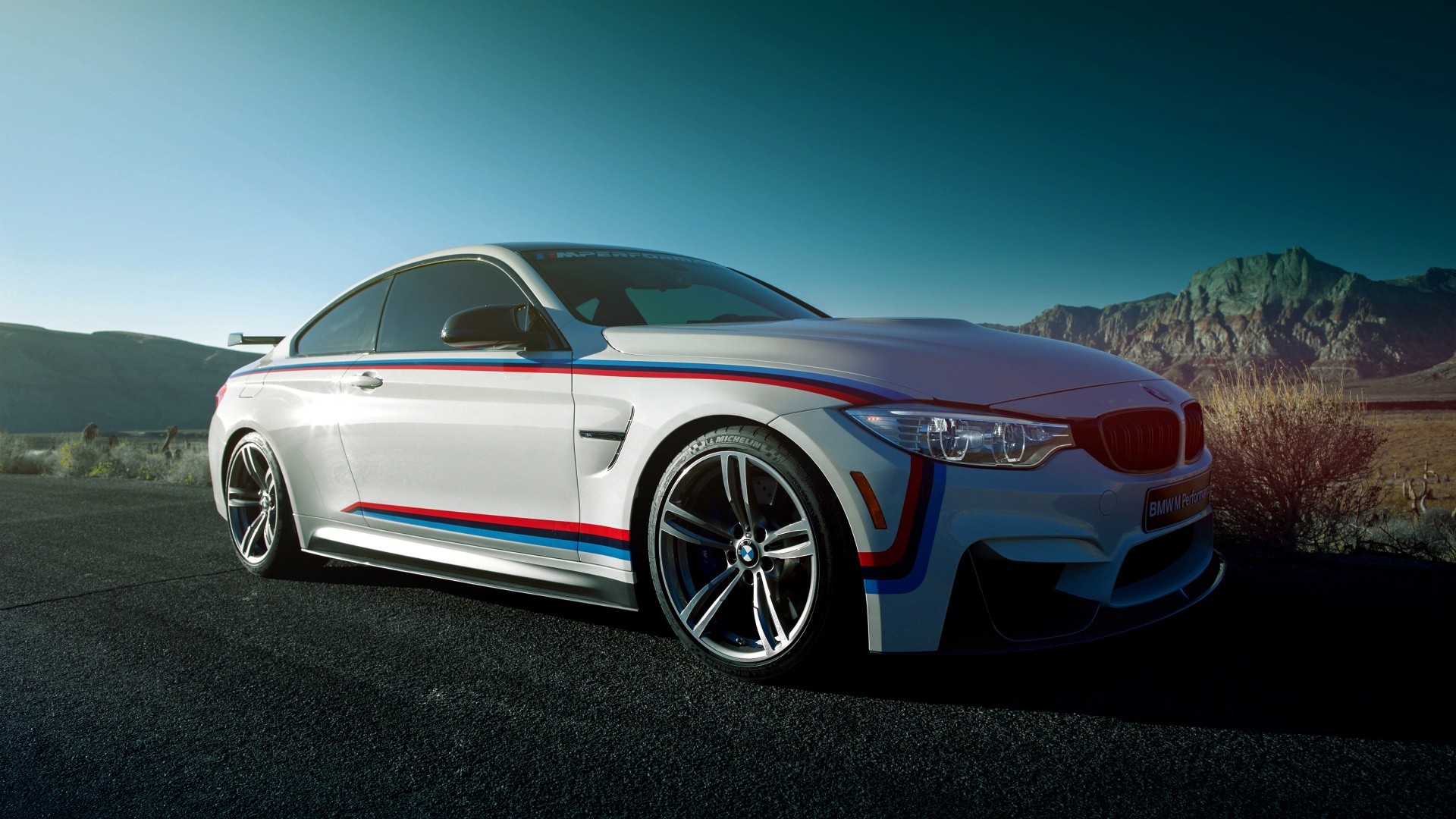 White BMW M4 Coupe with racing stripes HD Wallpaper
