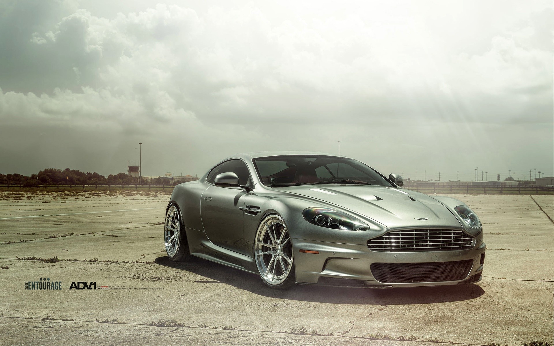 Silver Aston Martin DBS on a concrete surface HD Wallpaper