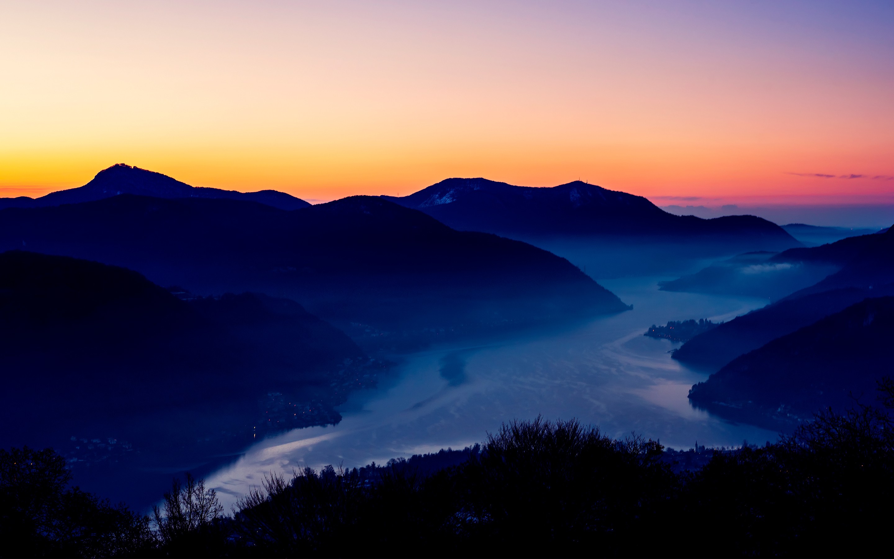 Mountains and lake at sunset with fog HD Wallpaper
