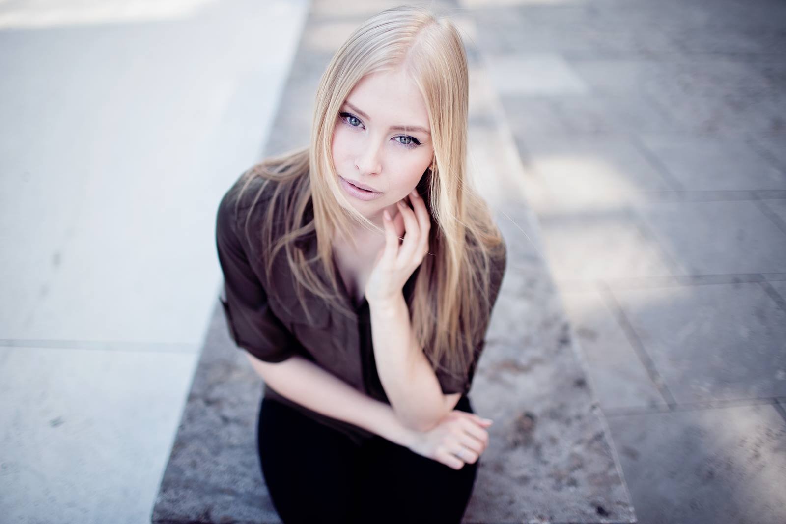 Blonde woman sitting and looking at the viewer HD Wallpaper