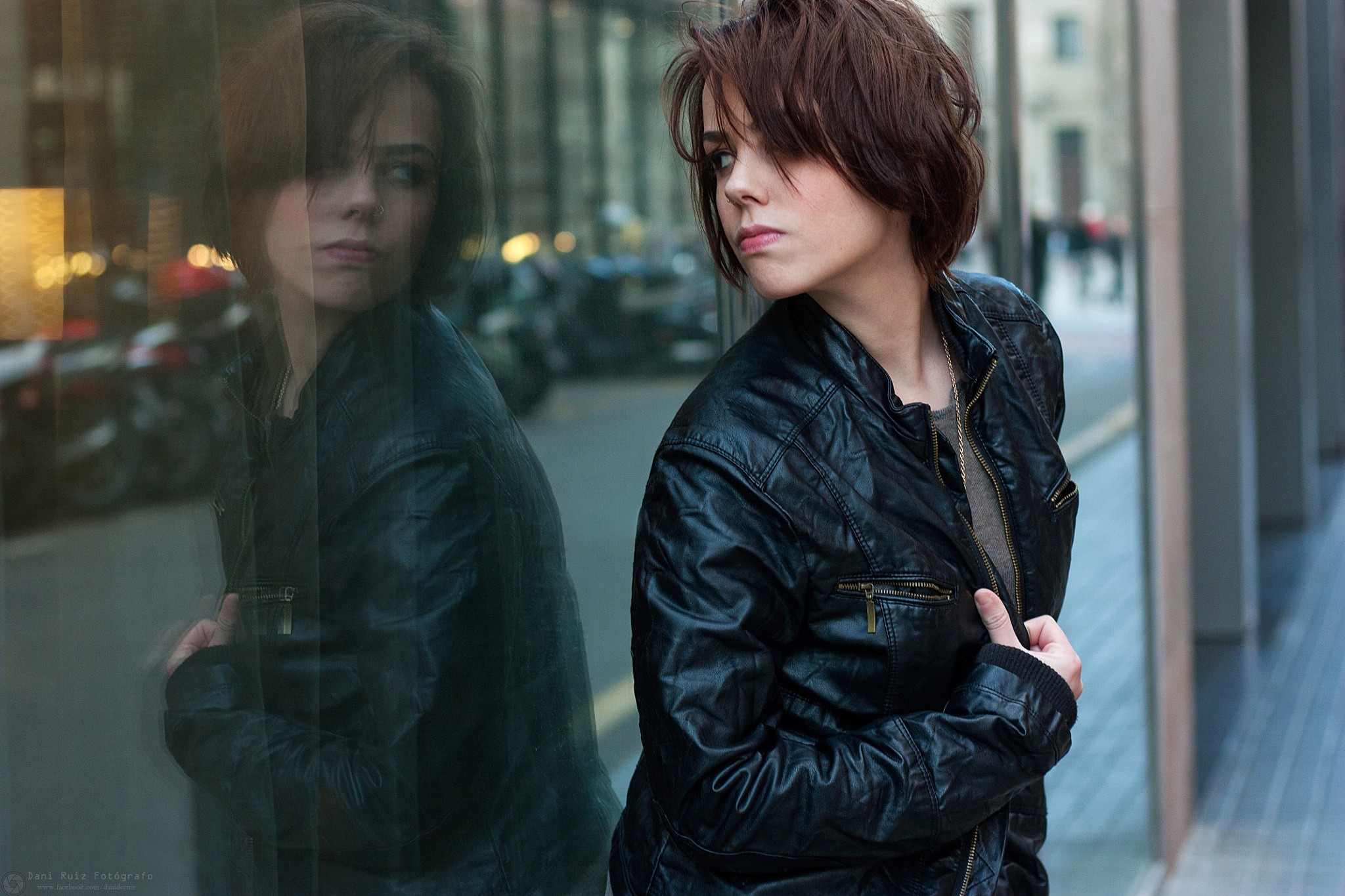 Woman with pierced nose in leather jacket reflected in glass HD Wallpaper