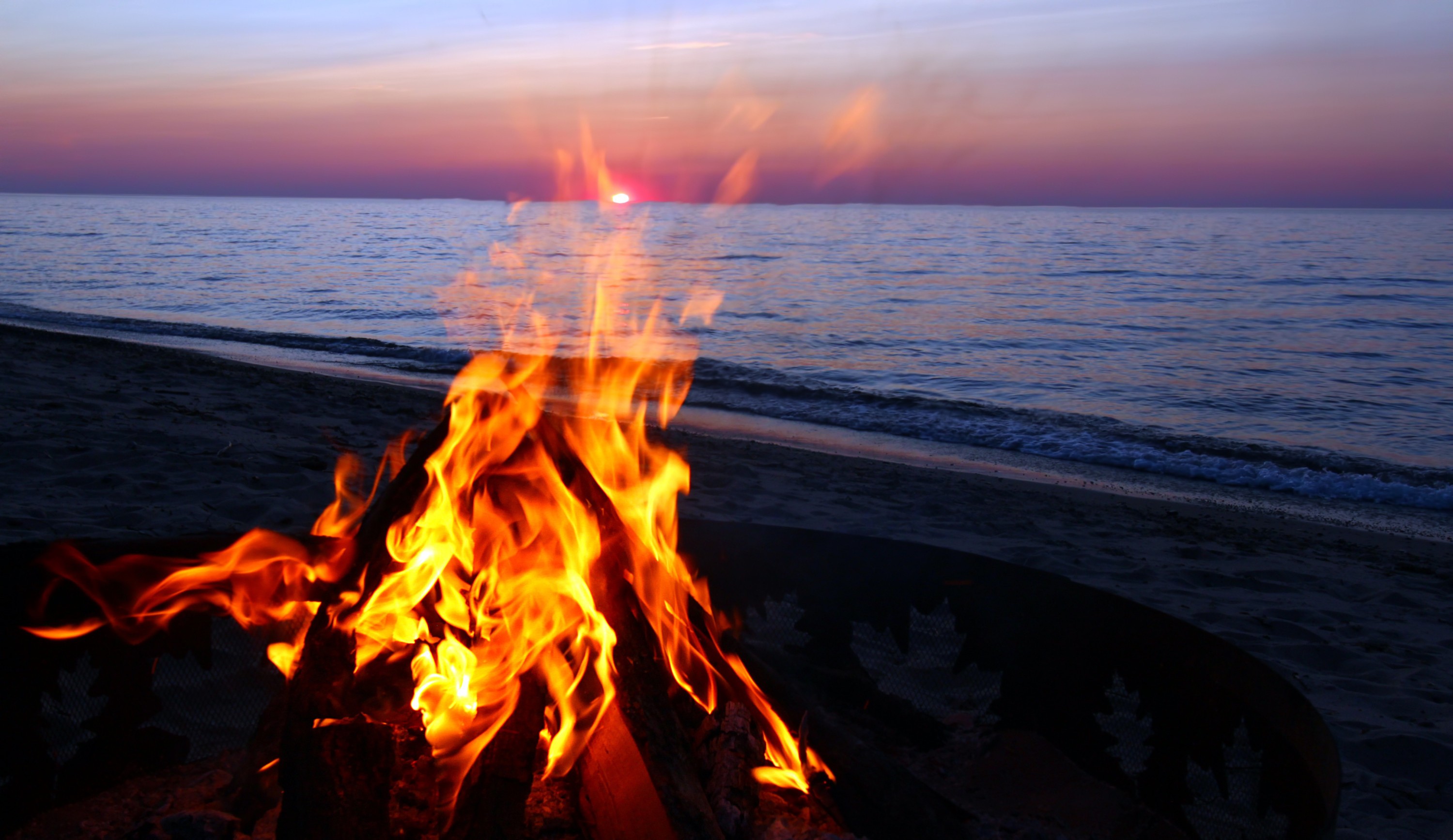 Bonfire on the beach at sunset HD Wallpaper