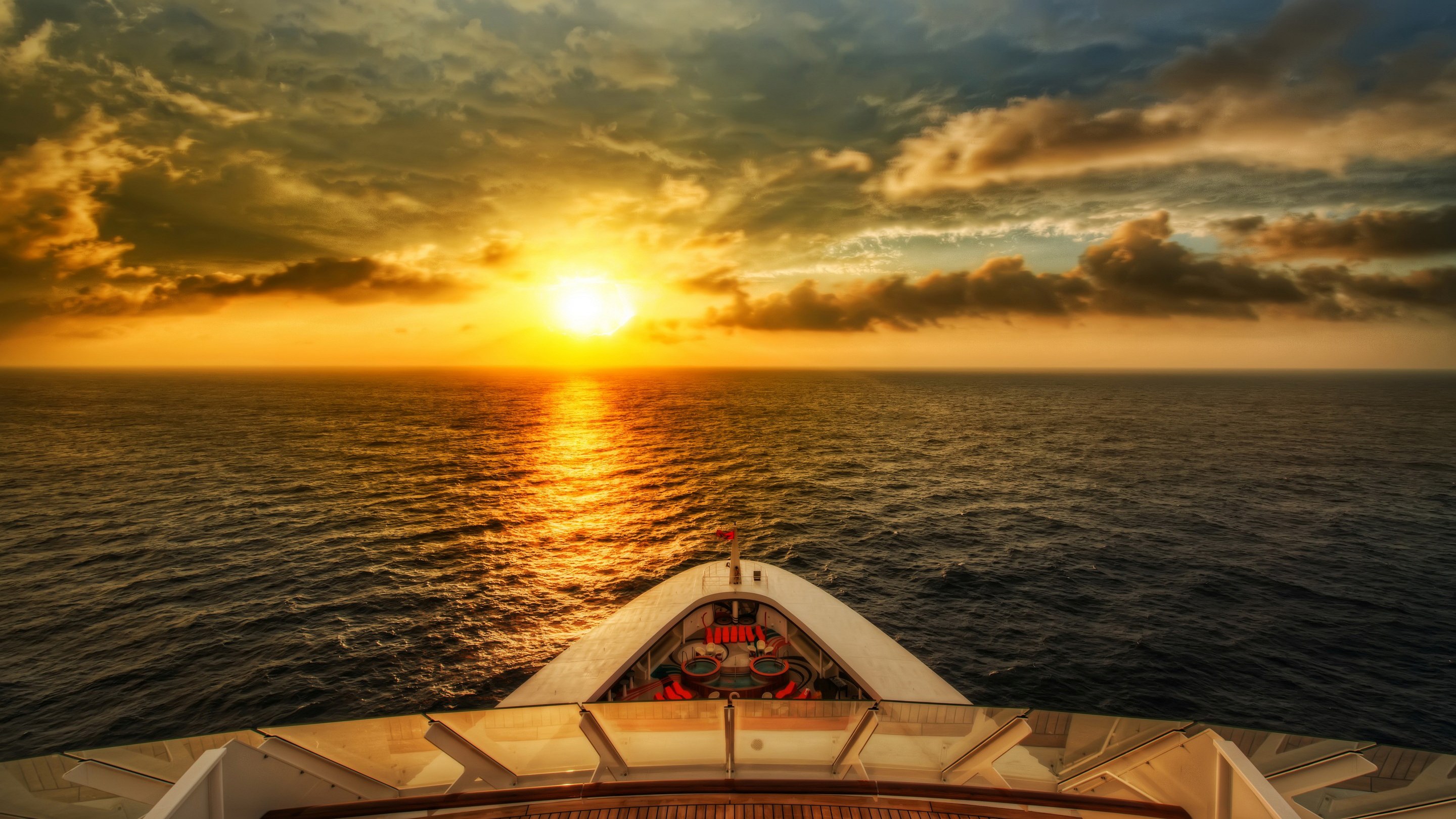 Cruise ship sailing into the sunset over the ocean HD Wallpaper