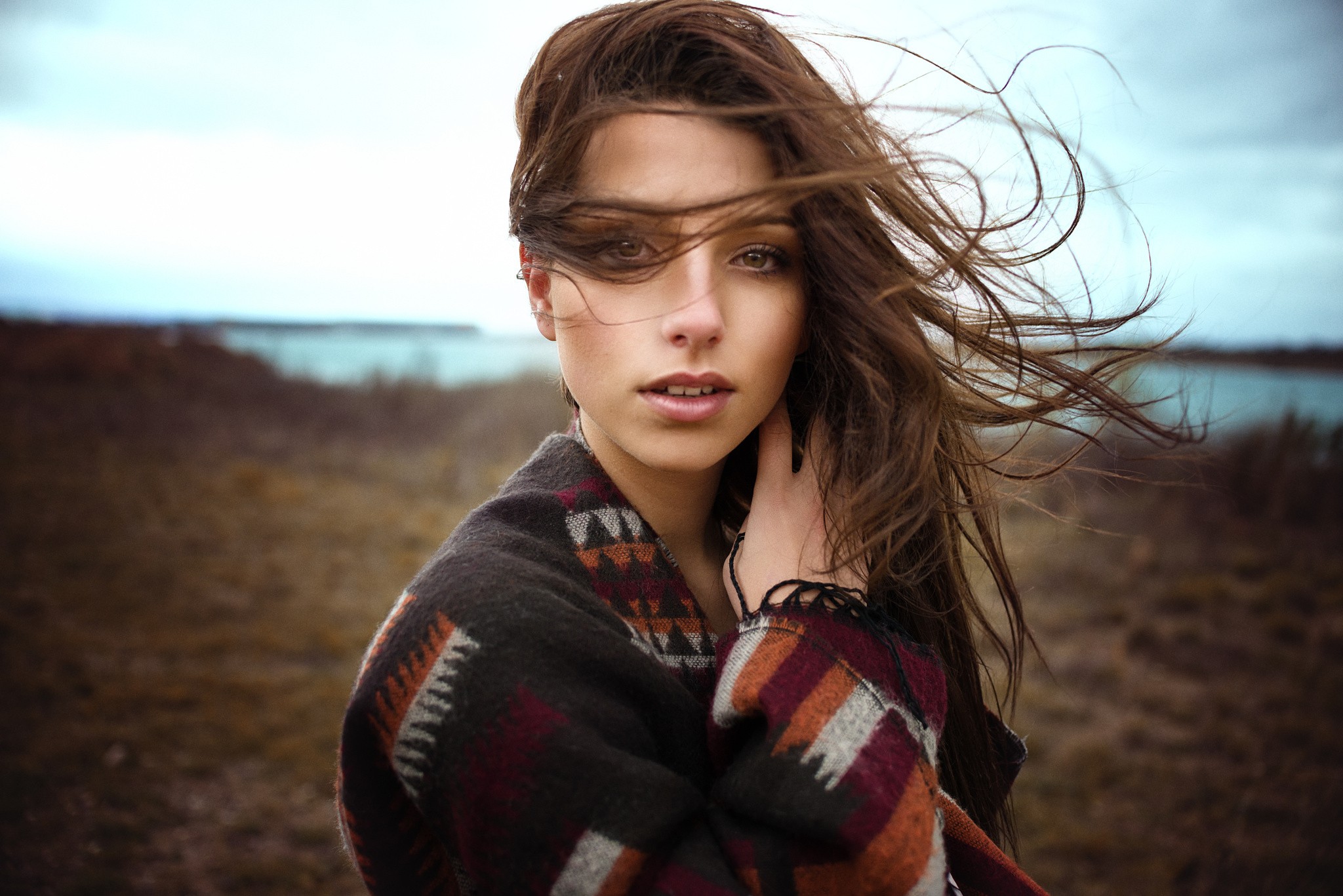 Portrait of a young woman with windblown hair HD Wallpaper