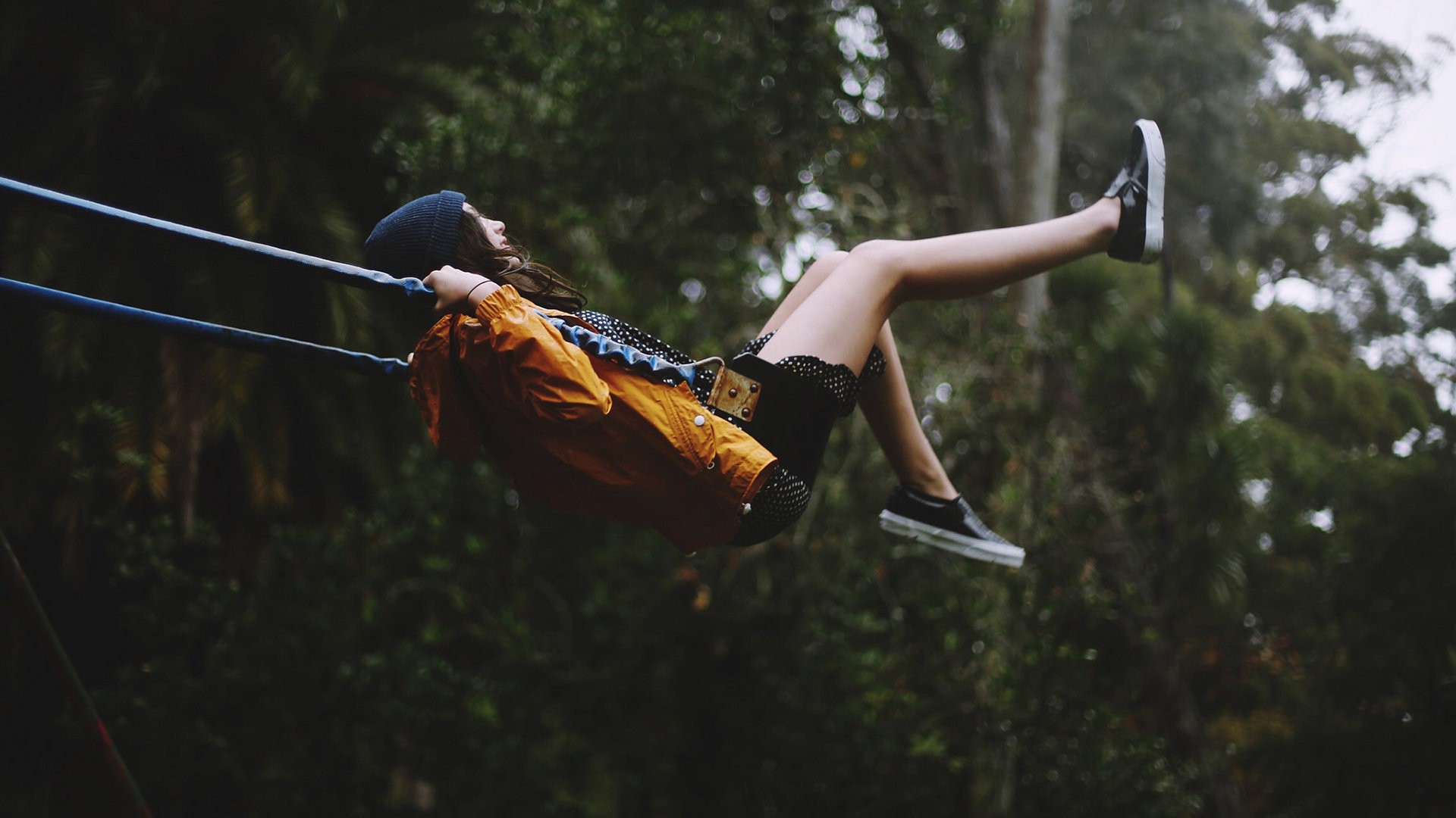 Woman on a swing in a forest HD Wallpaper