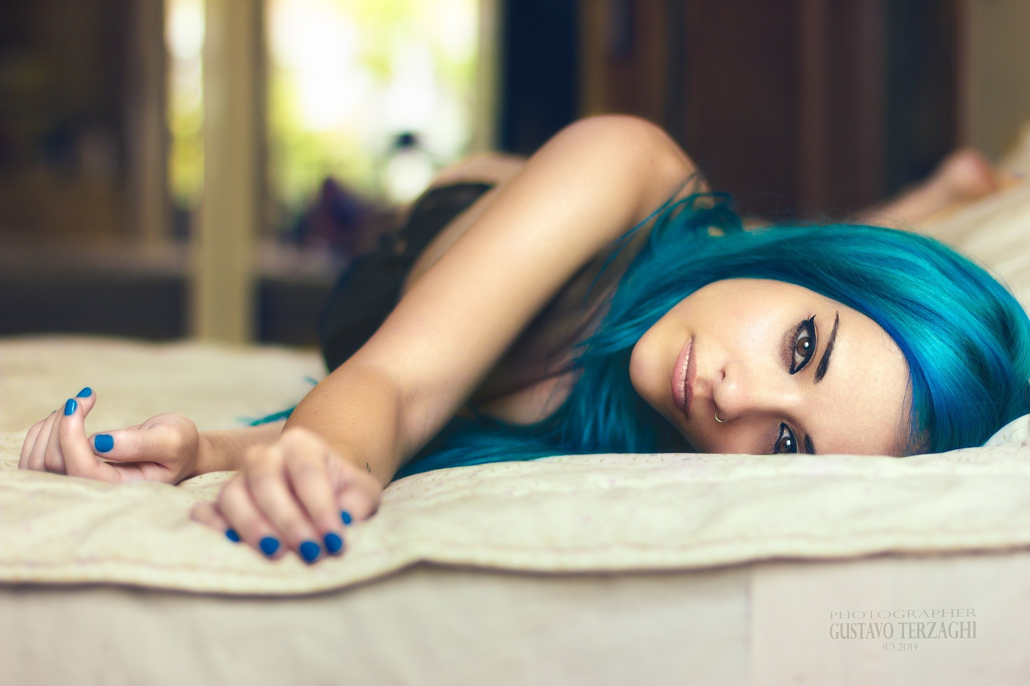 Woman with blue dyed hair lying in bed HD Wallpaper