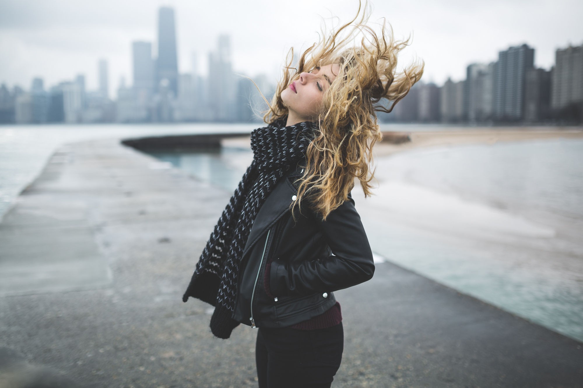Woman with blonde hair in the wind by the water HD Wallpaper