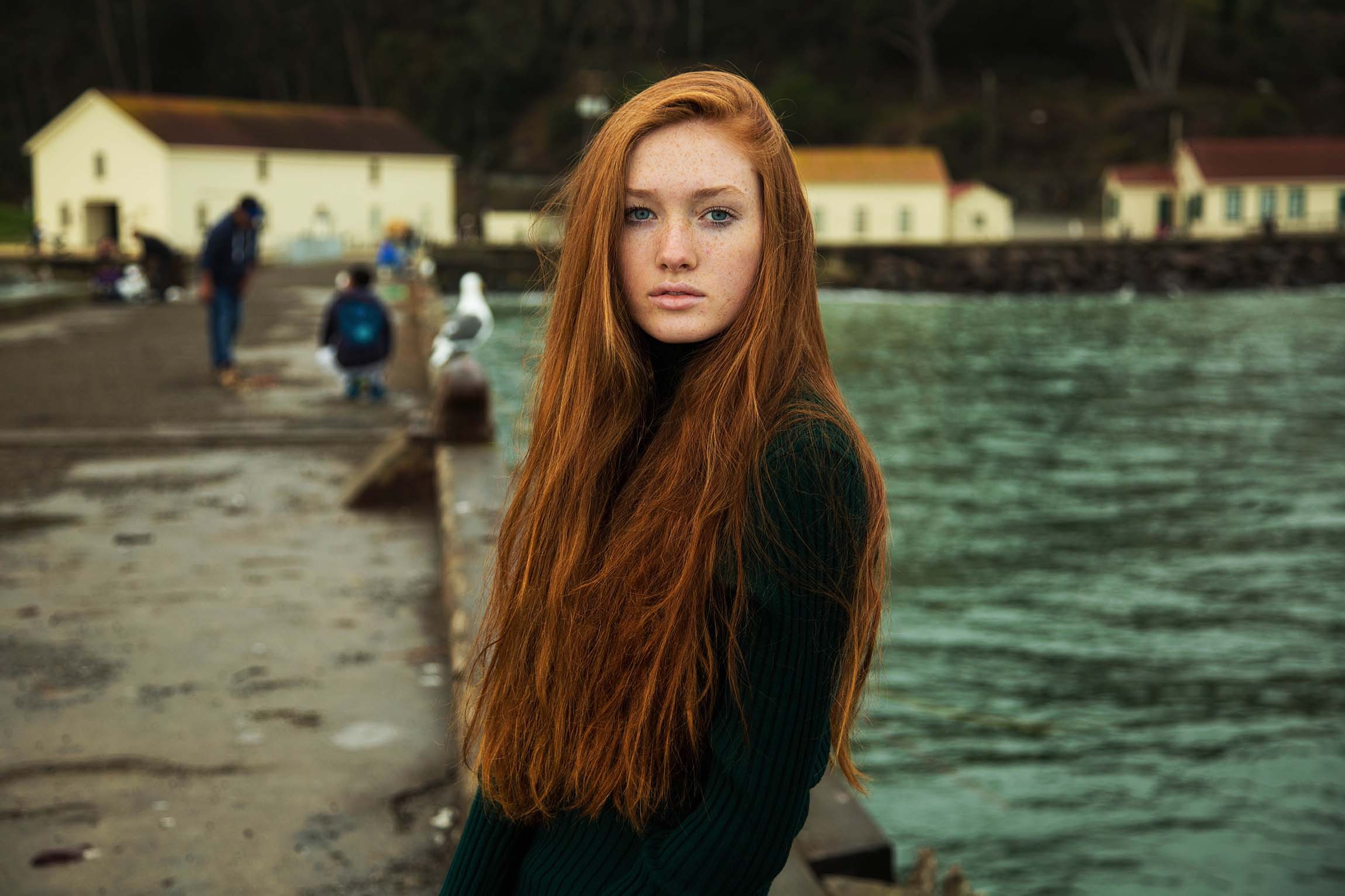 Redhead woman with long hair by the water HD Wallpaper