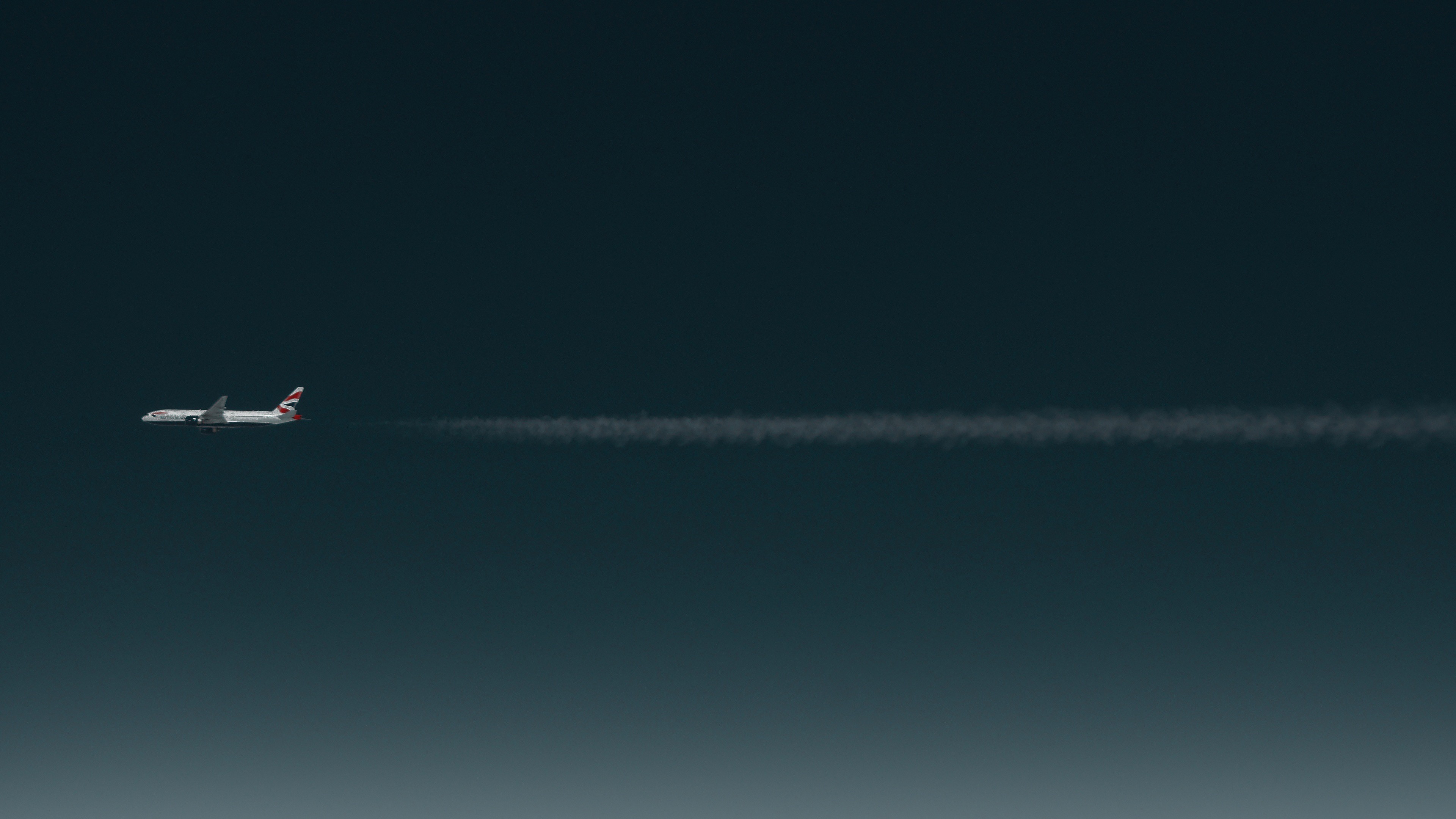 British Airways airplane flying through the sky leaving contrails HD Wallpaper