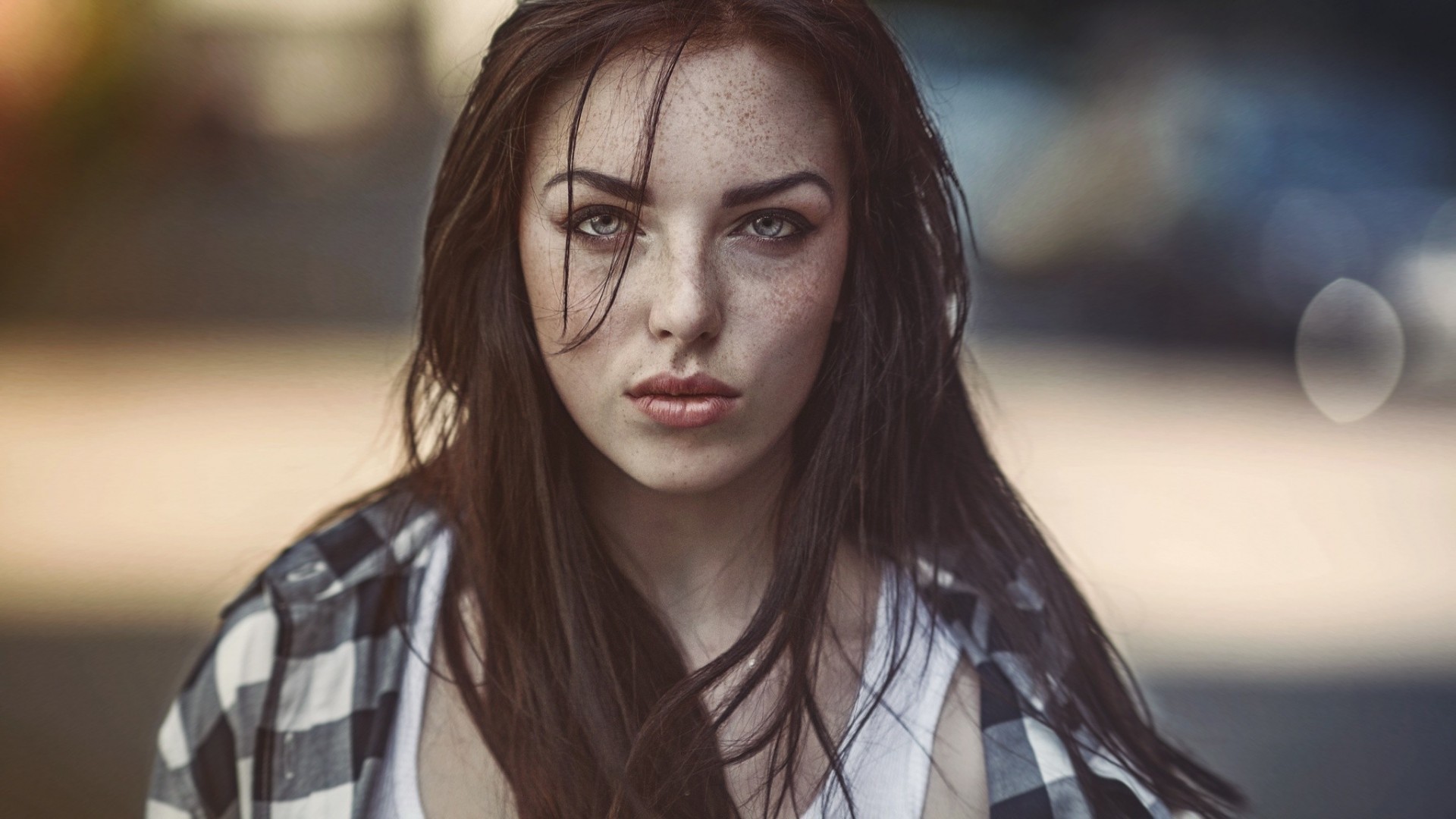 Woman with freckles and blue eyes wearing a plaid shirt HD Wallpaper