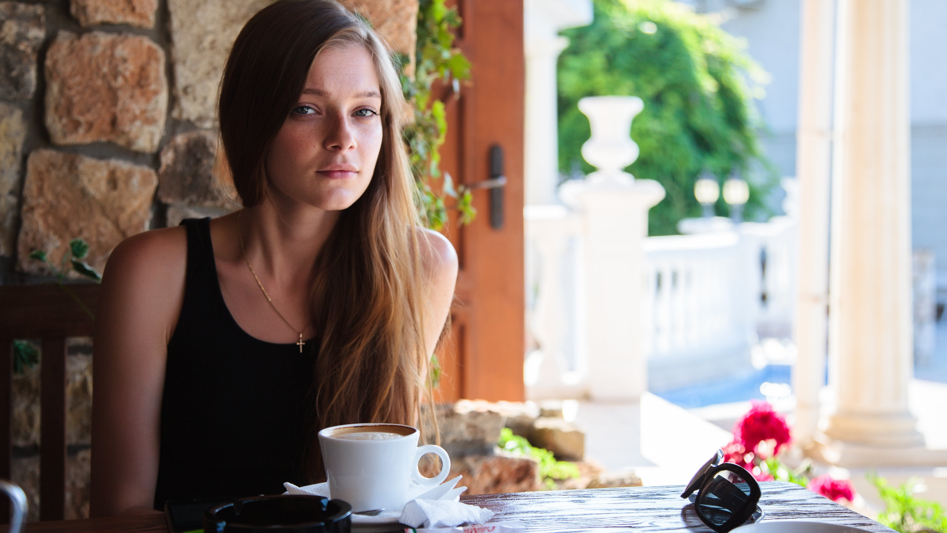 Woman sitting at a table with coffee HD Wallpaper