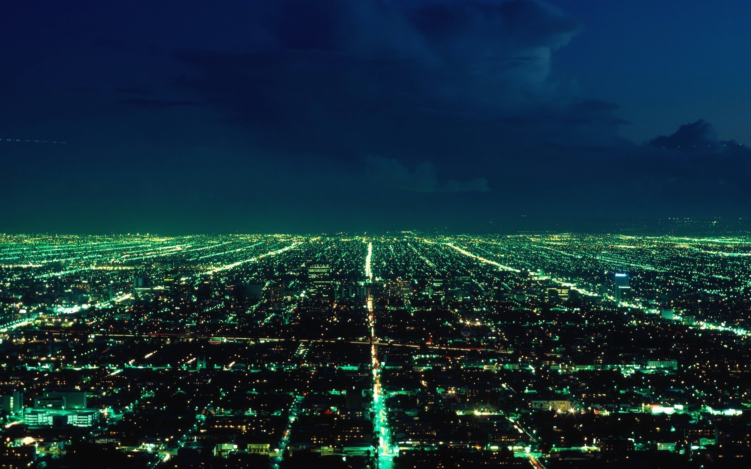 Aerial view of a sprawling city at night HD Wallpaper
