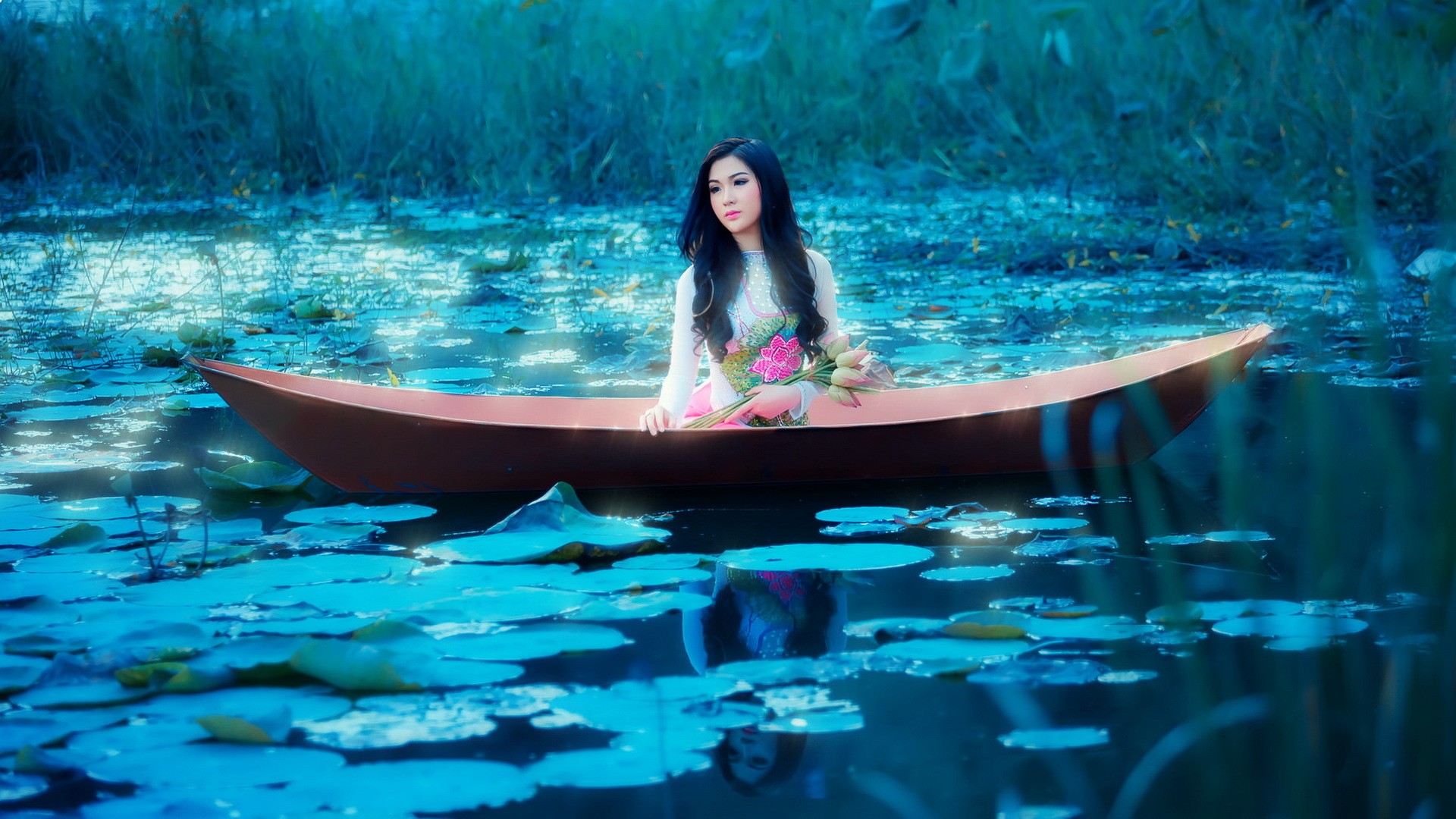 Asian woman in a boat with lotus flowers HD Wallpaper