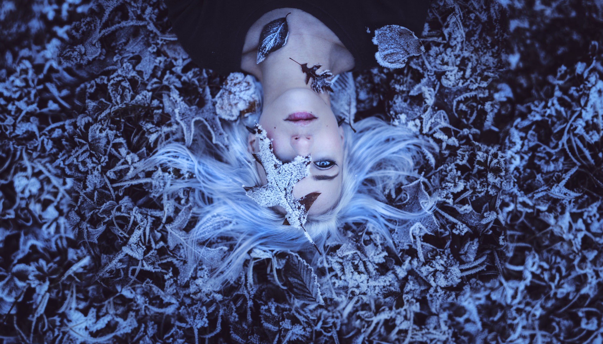Woman with white hair lying in frosted leaves HD Wallpaper
