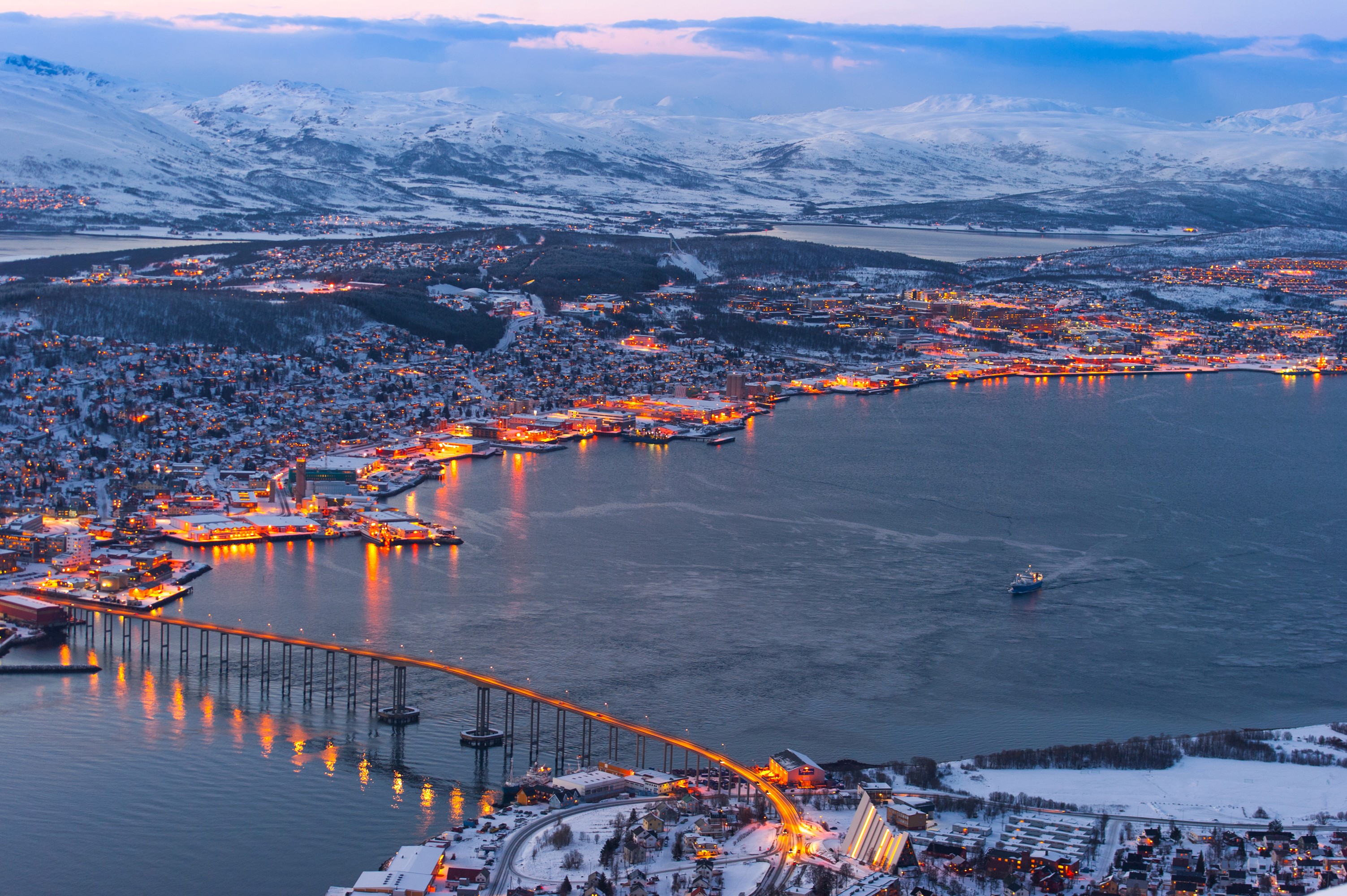 Tromsø, Norway illuminated at dusk with snow-capped mountains HD Wallpaper