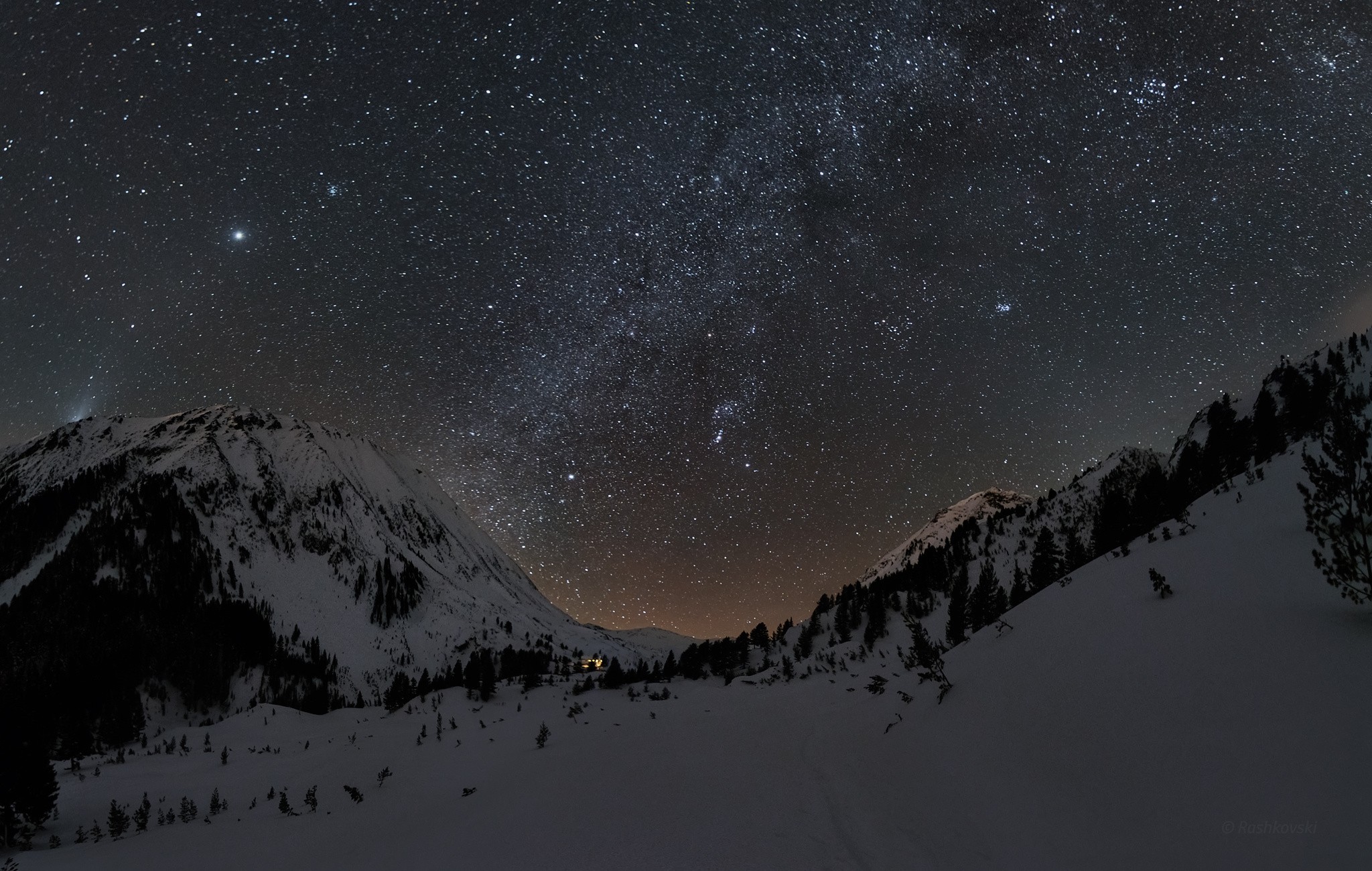Starry night sky over snow-covered mountains HD Wallpaper