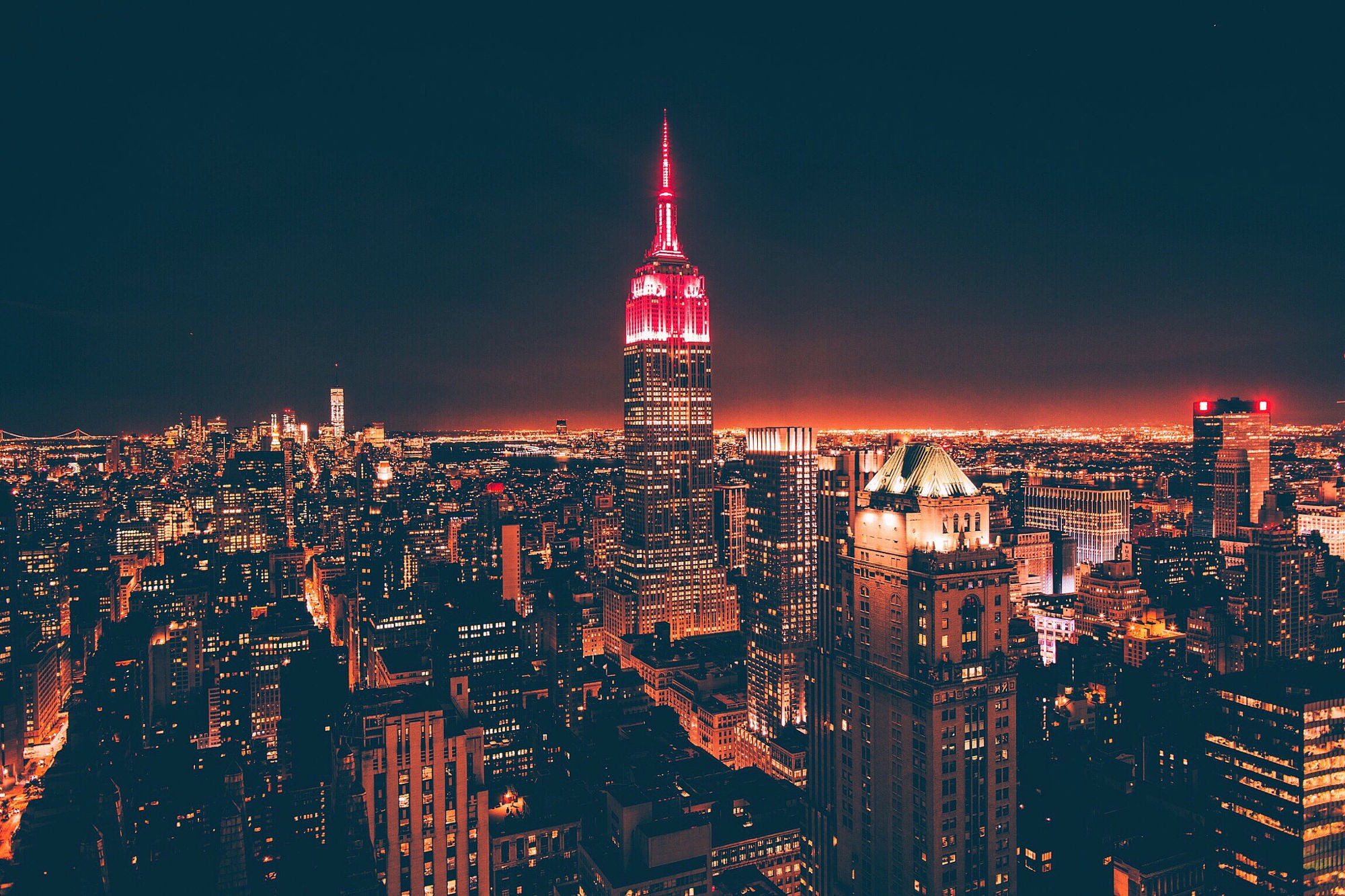 Empire State Building illuminated red at night cityscape HD Wallpaper