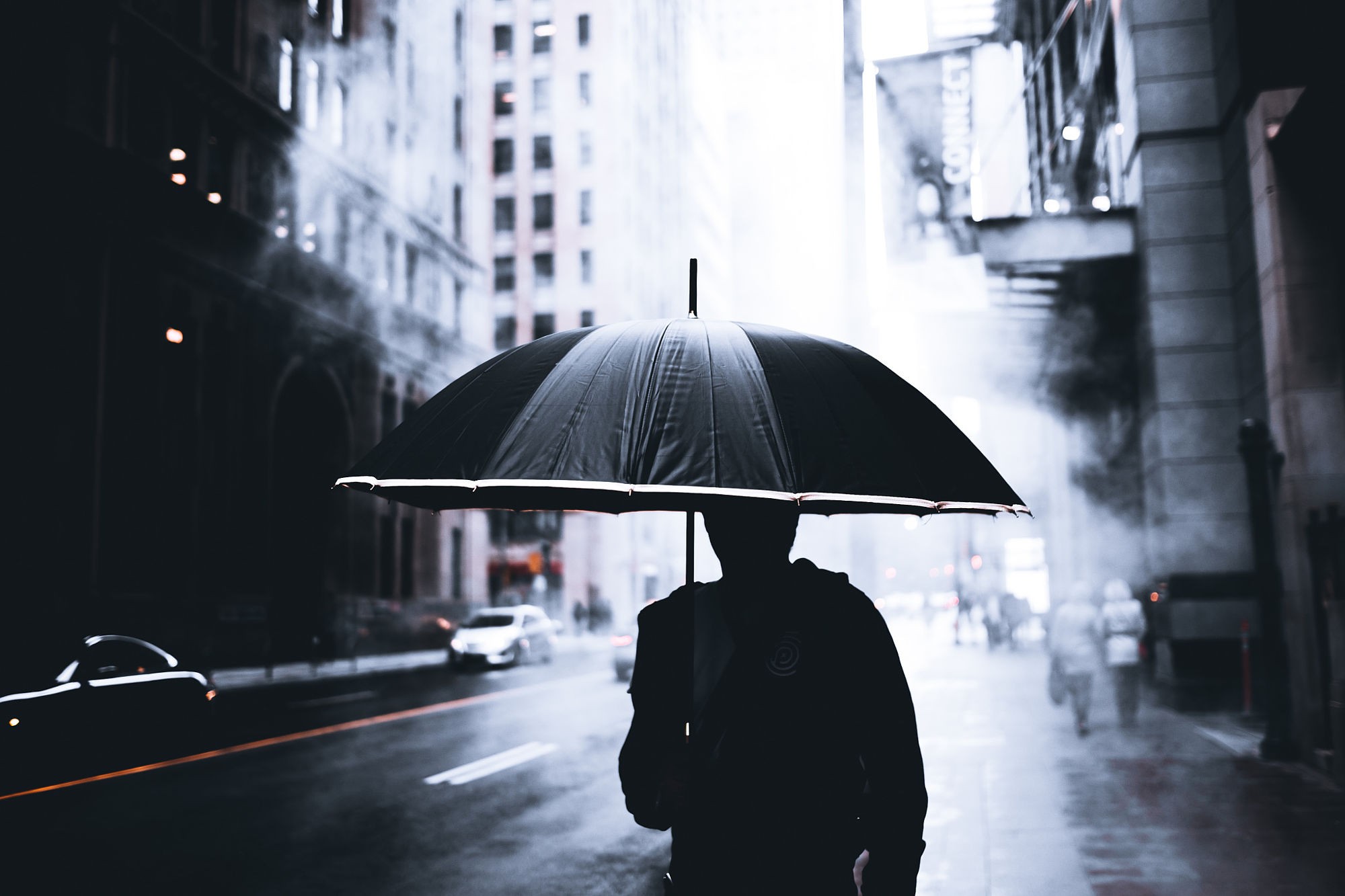 Silhouette with umbrella in rainy Toronto cityscape HD Wallpaper