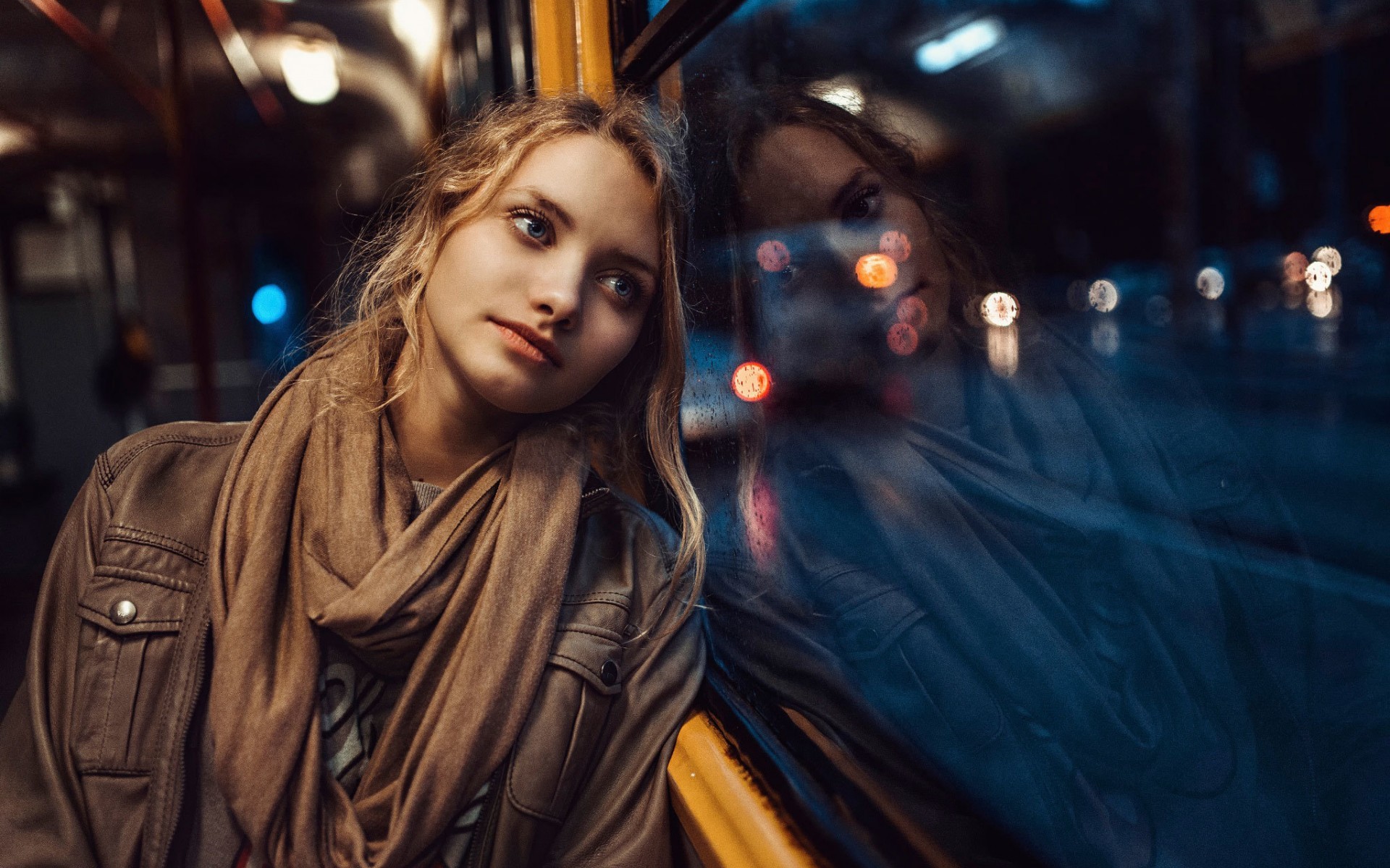 Woman with scarf leaning against window on vehicle HD Wallpaper