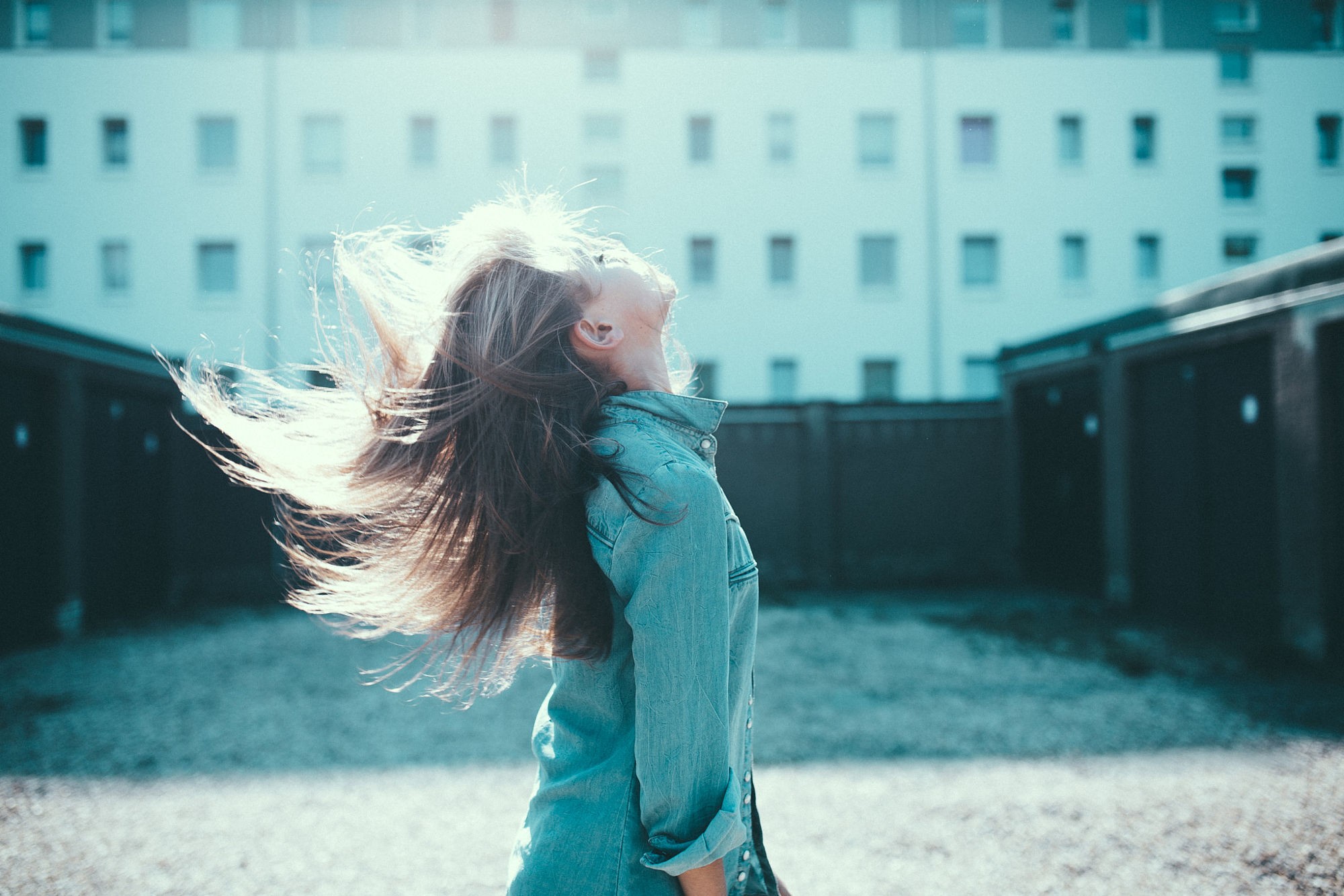 Woman in denim shirt with hair blowing HD Wallpaper