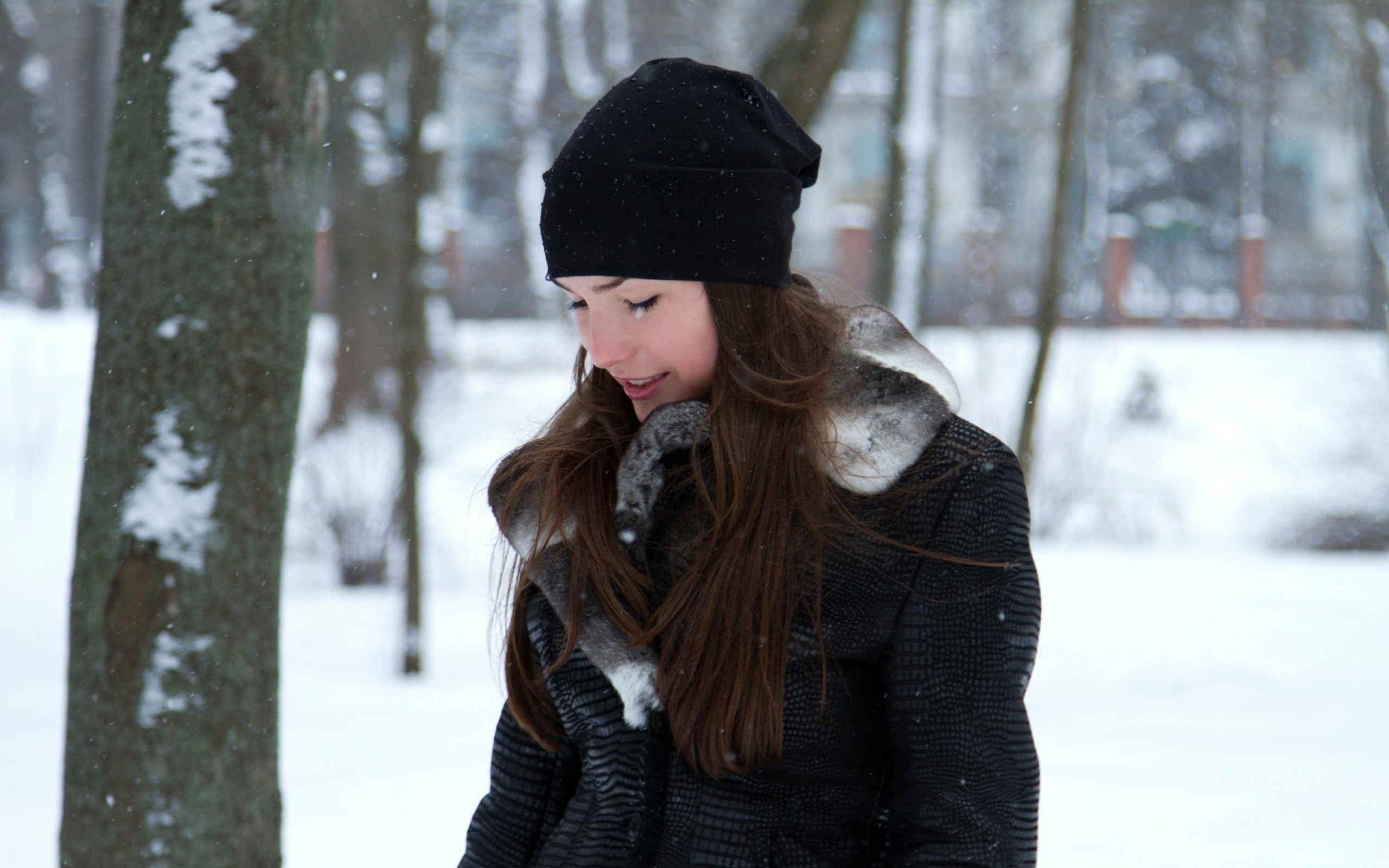 Woman in black beanie and jacket in winter park HD Wallpaper