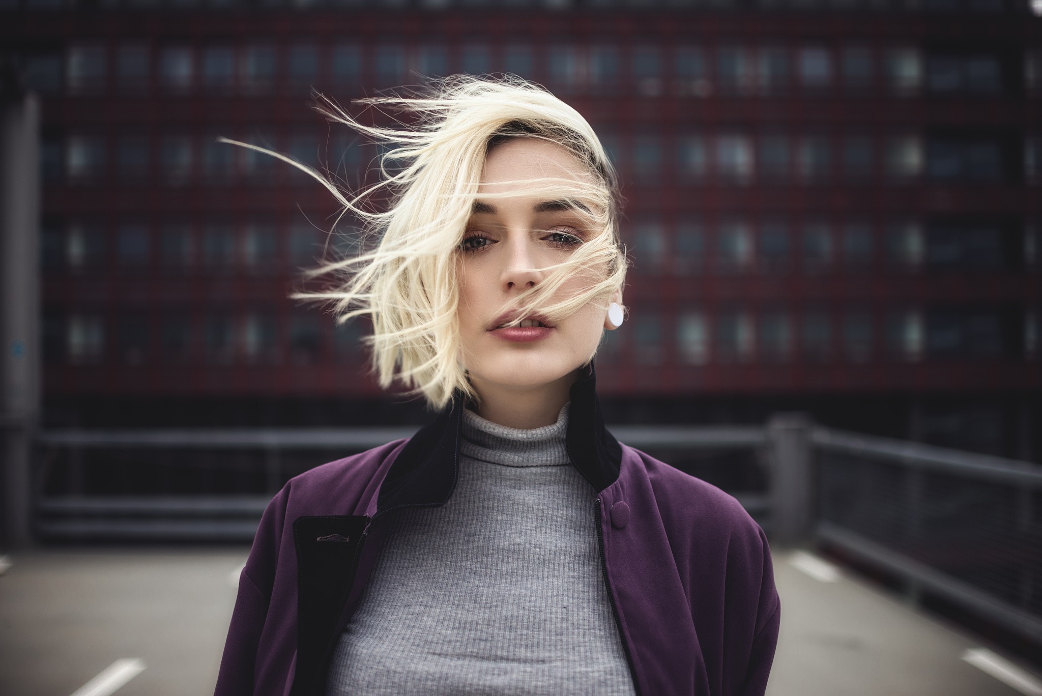Woman with blonde hair in a purple jacket HD Wallpaper