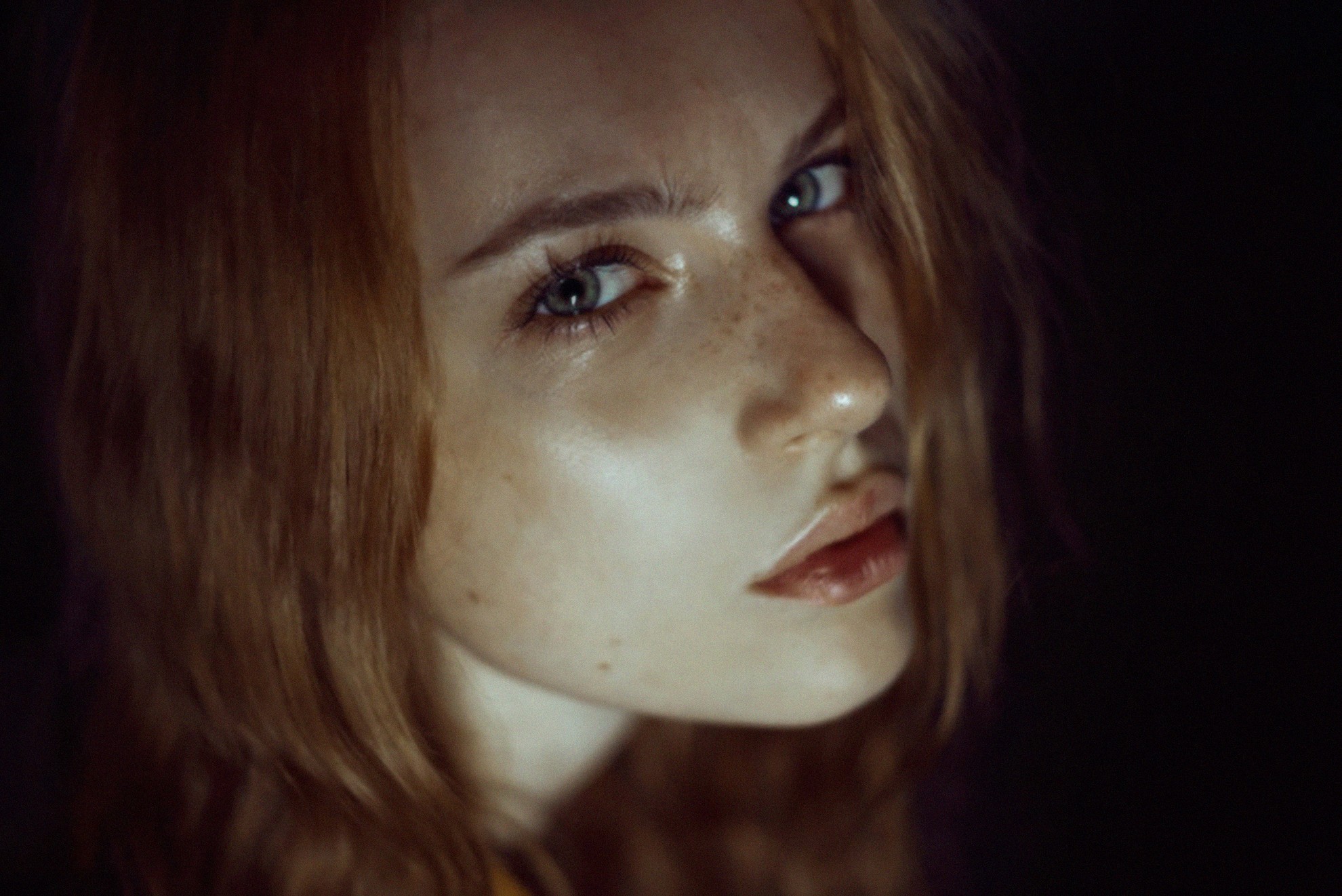 Close-up portrait of a young woman with freckles HD Wallpaper