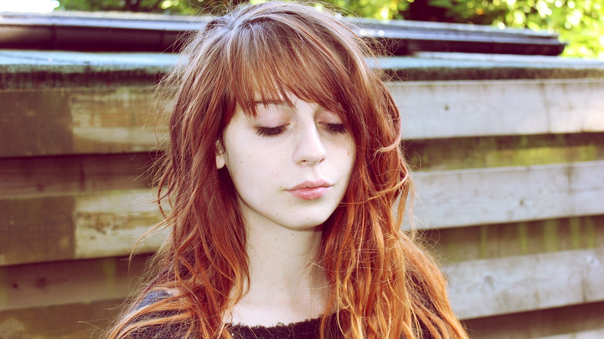 Woman with long auburn hair and bangs HD Wallpaper