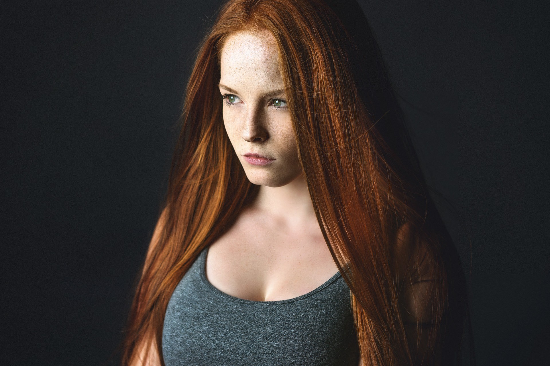 Redhead woman with freckles looking away HD Wallpaper