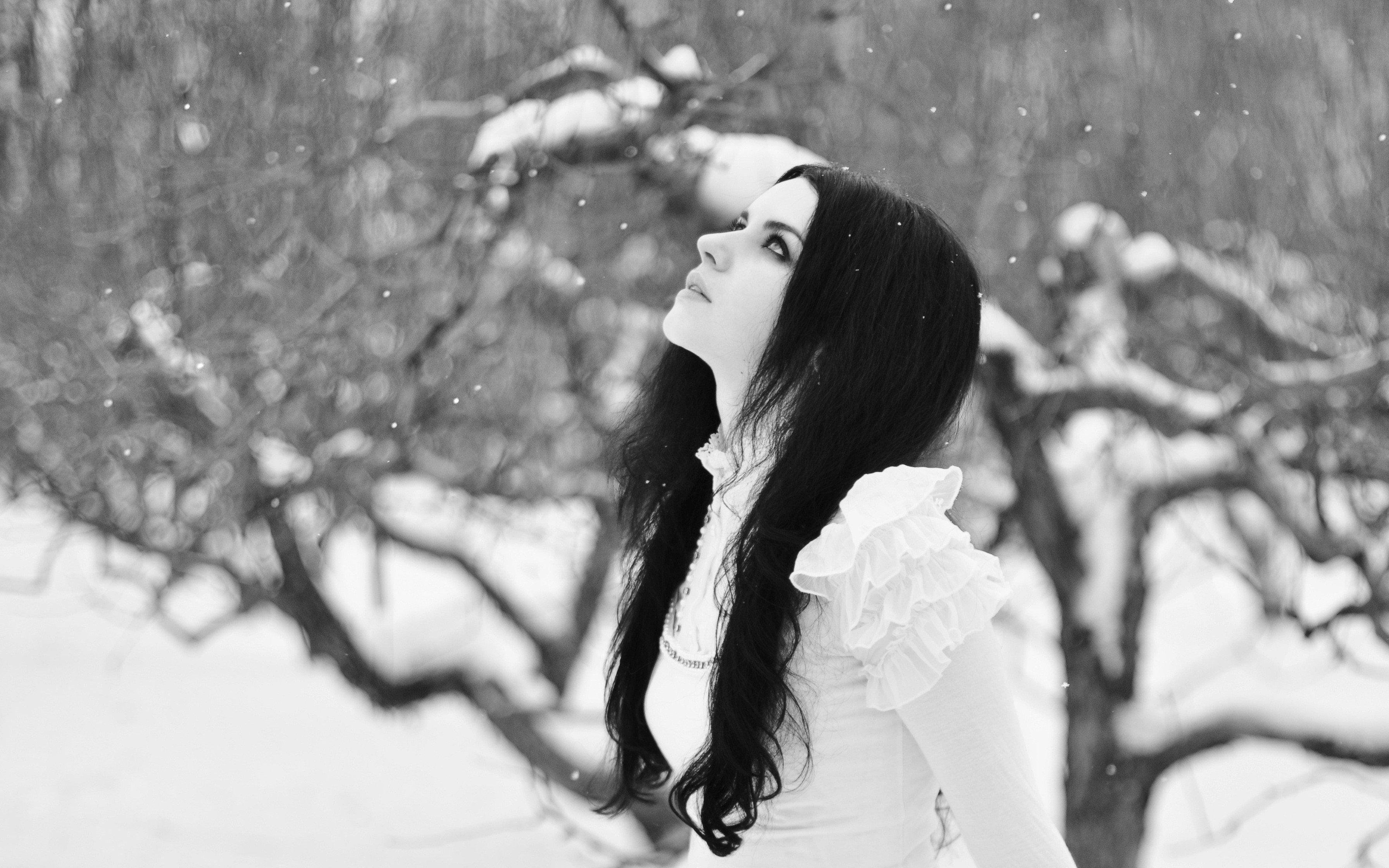 Woman with dark hair in the snow HD Wallpaper