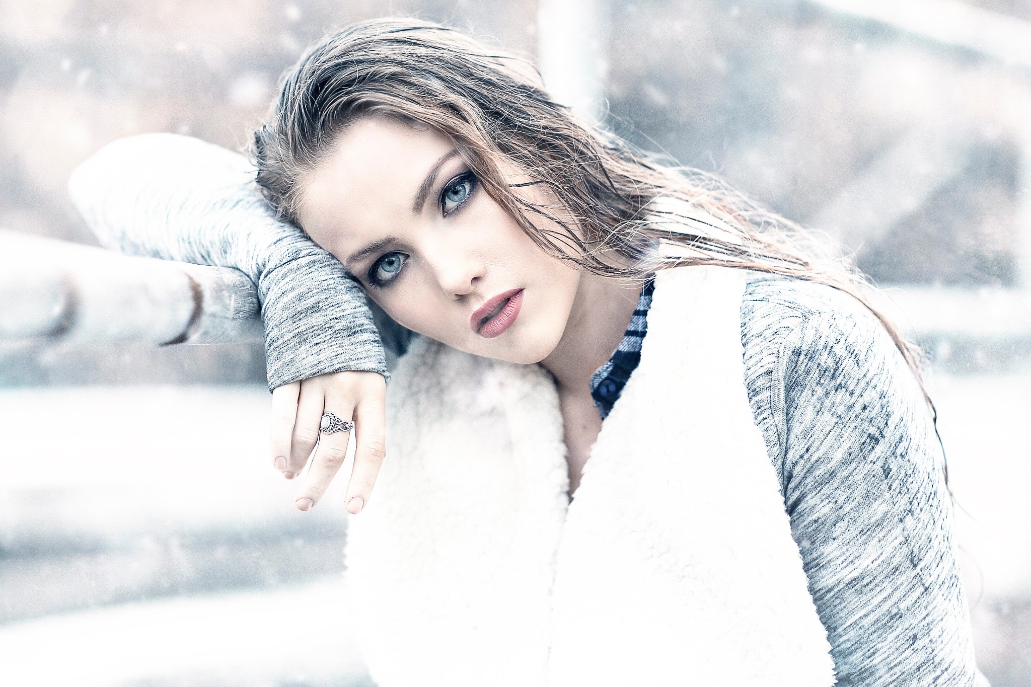 Woman in snow leaning on a fence HD Wallpaper