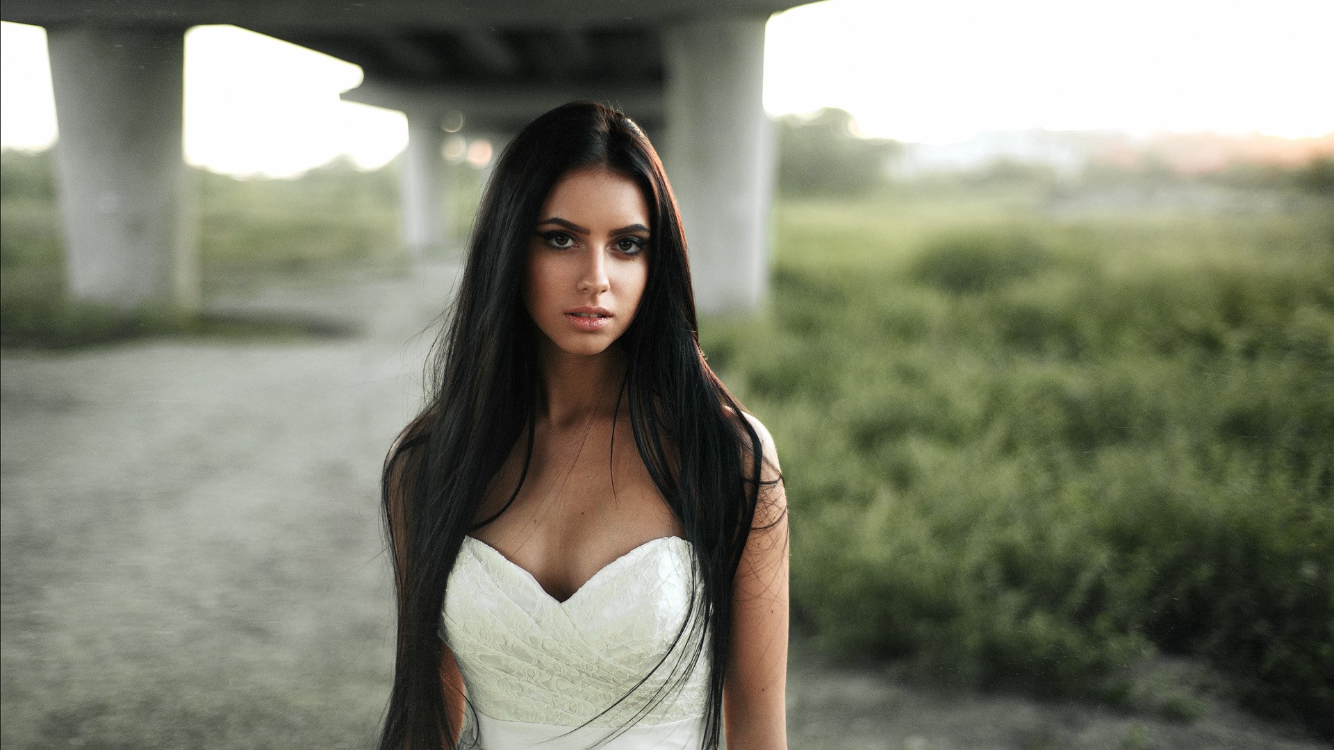 Woman in a white dress under a bridge HD Wallpaper