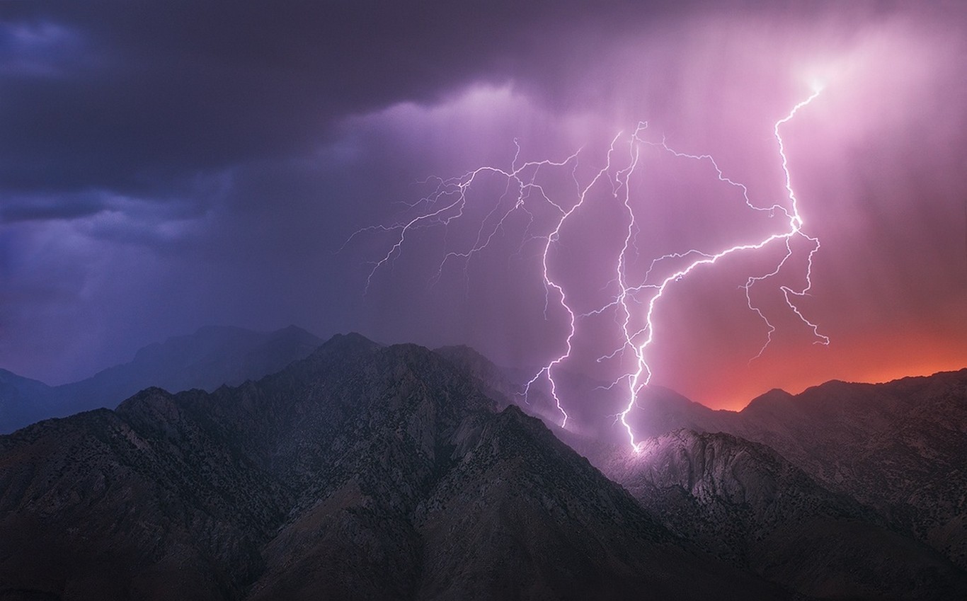 Lightning strikes mountains in Death Valley during a storm HD Wallpaper