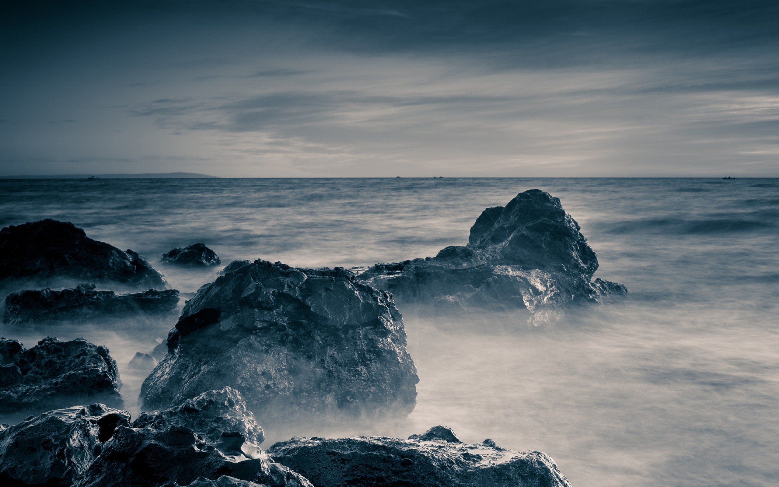 Rocks in the sea with misty water HD Wallpaper