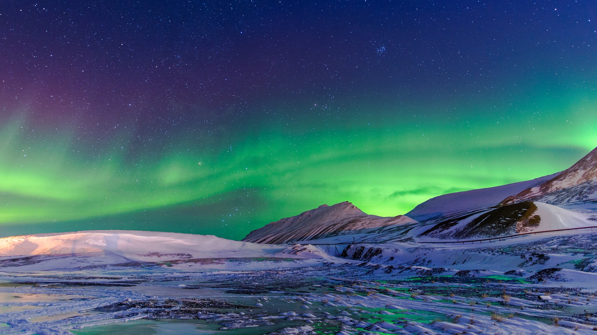 Aurora Borealis over snowy mountains in Norway HD Wallpaper