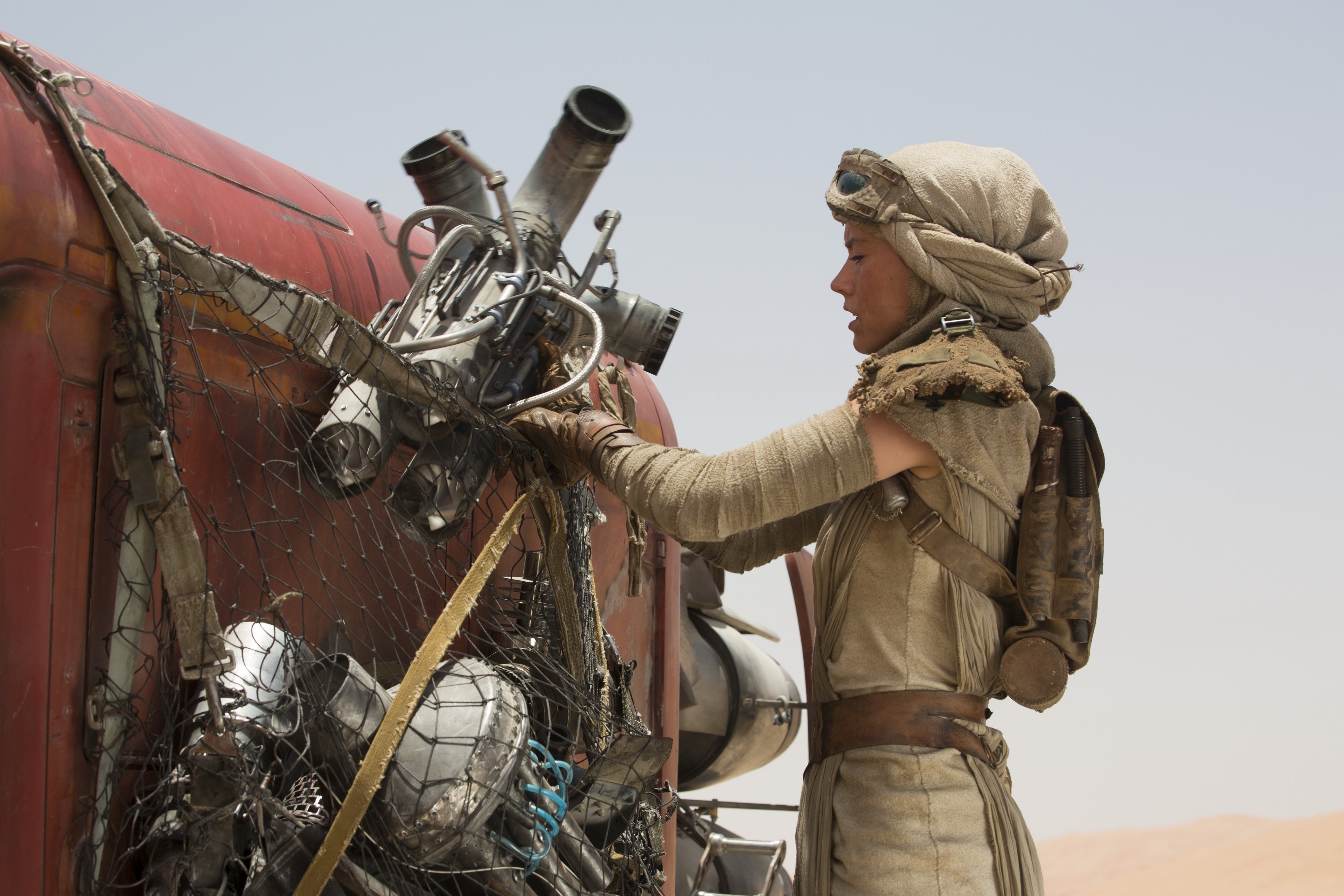 Rey working on a vehicle in Star Wars: The Force Awakens HD Wallpaper