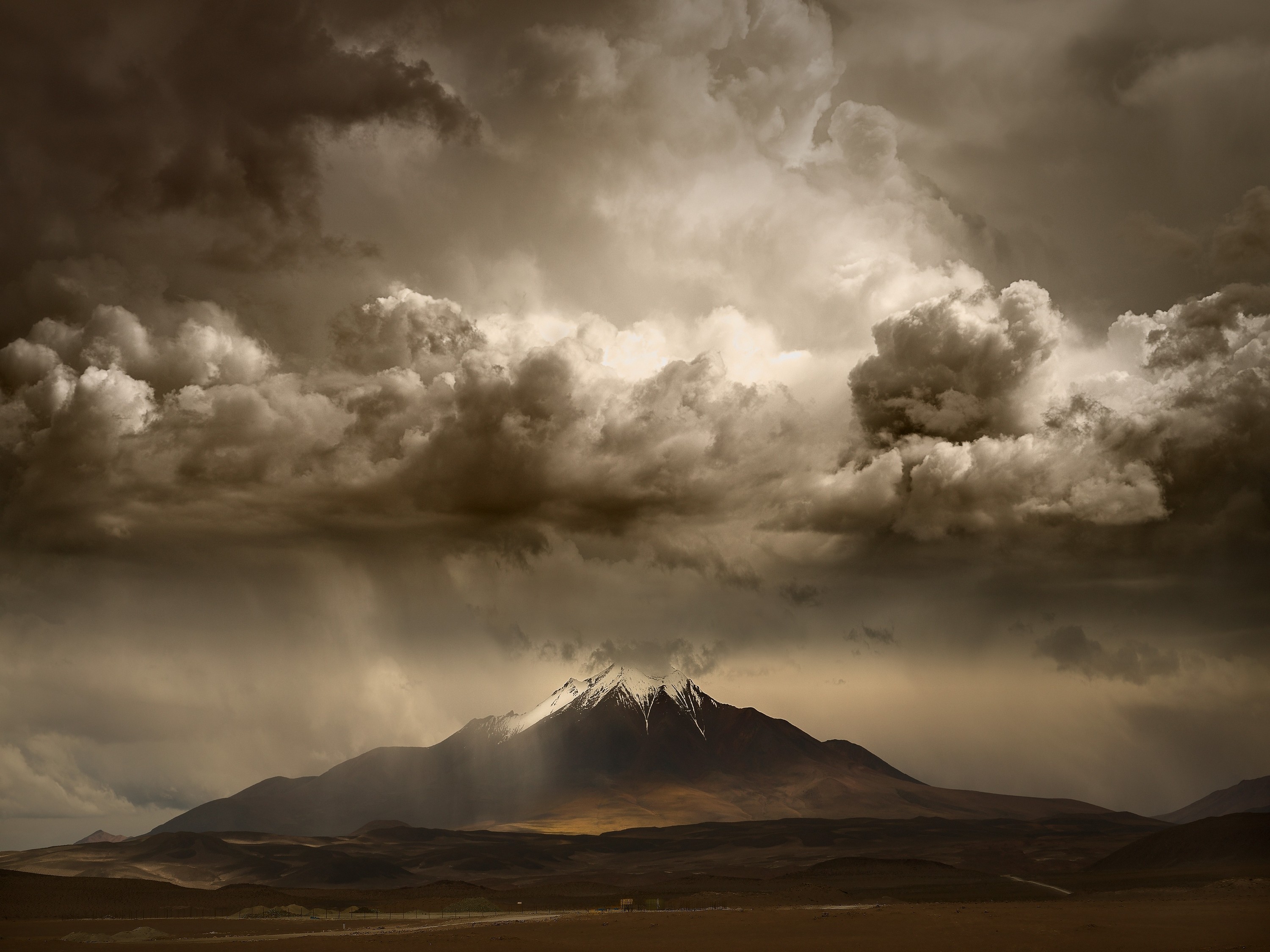 Stormy sky over a snowy mountain peak HD Wallpaper