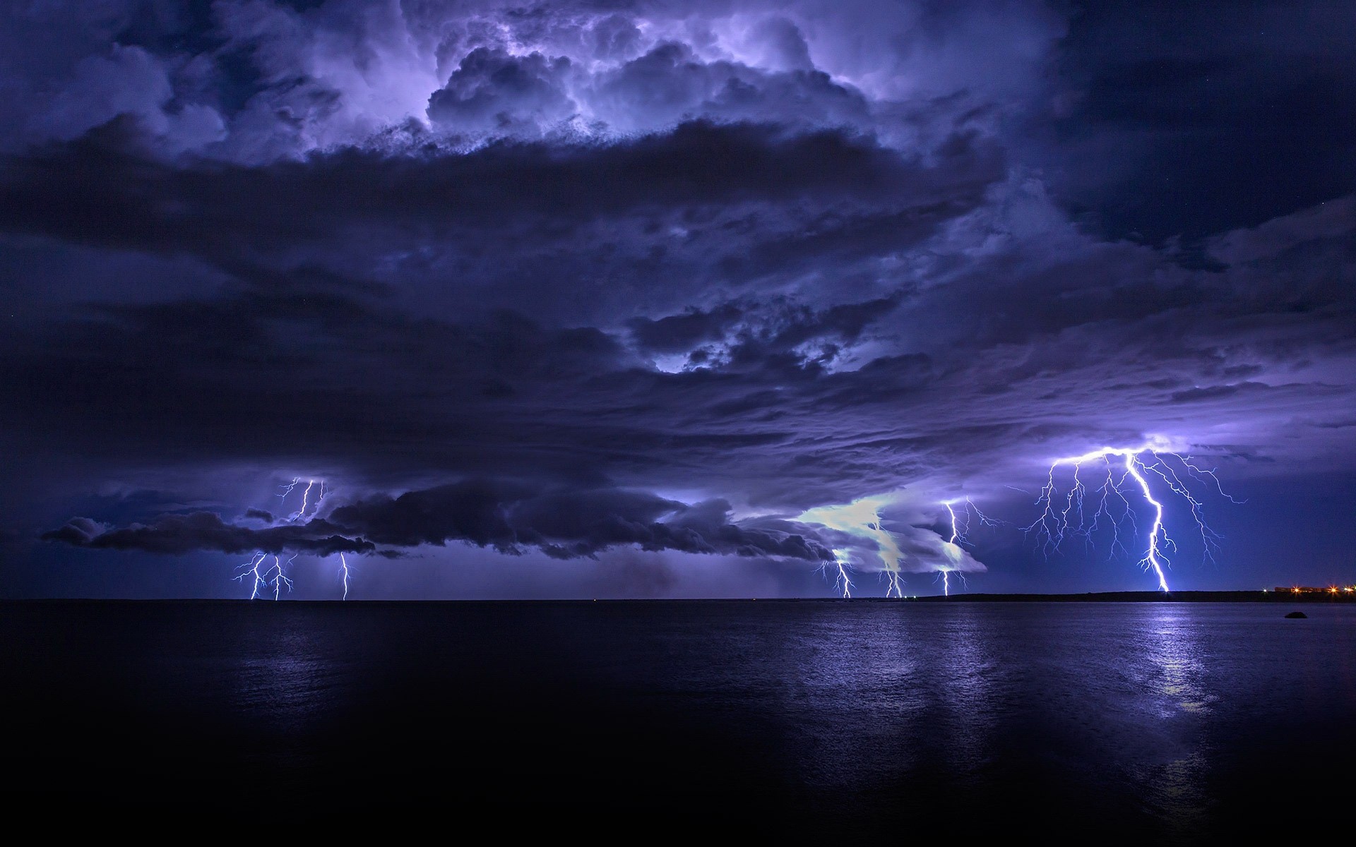 Lightning strikes over the ocean during a storm HD Wallpaper