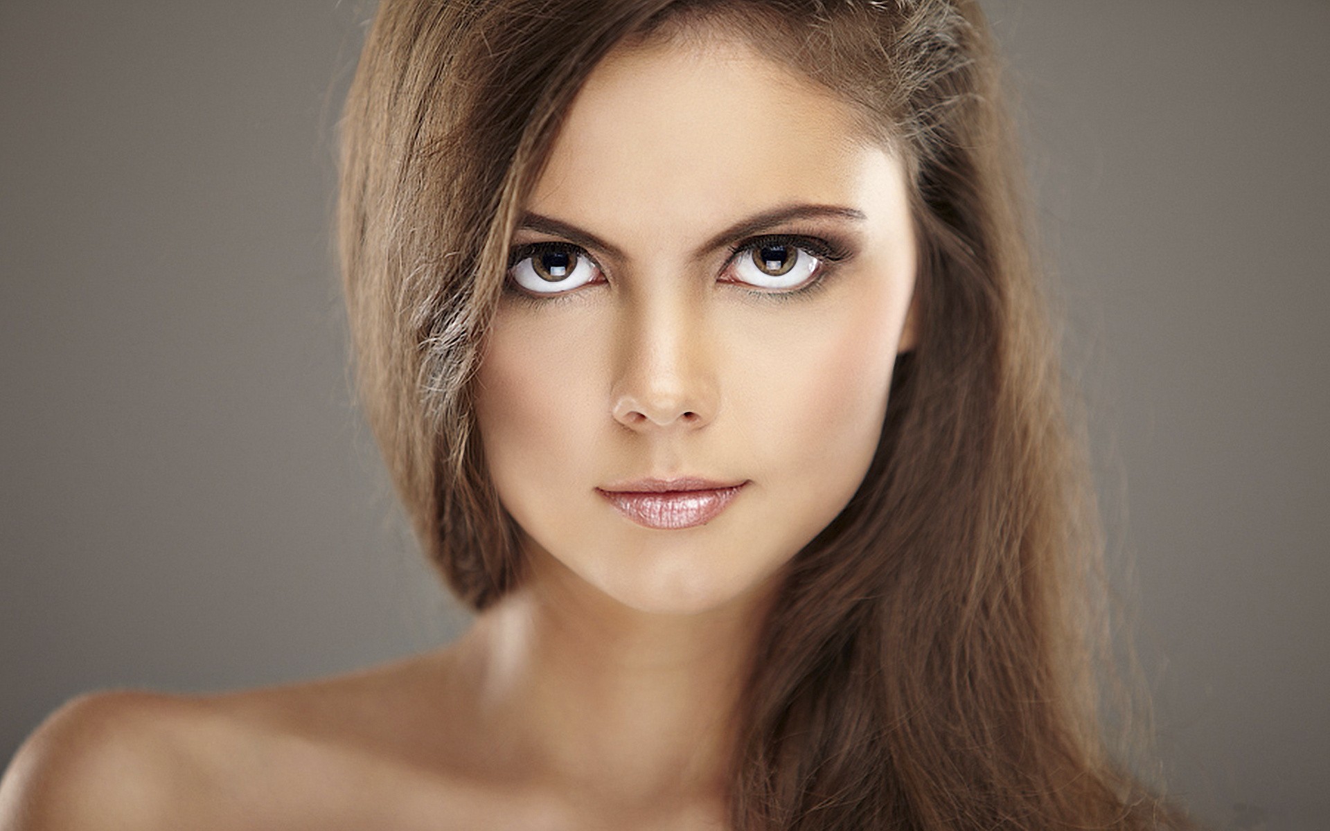 Woman with long brown hair and makeup HD Wallpaper