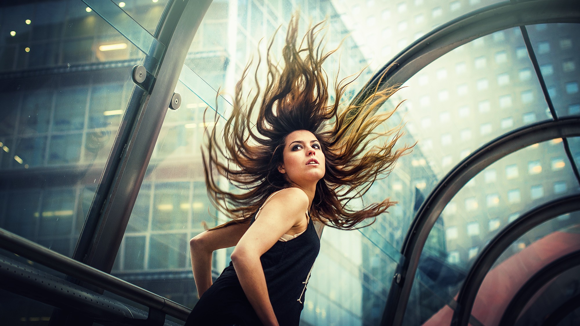 Woman with hair flying in a modern building HD Wallpaper